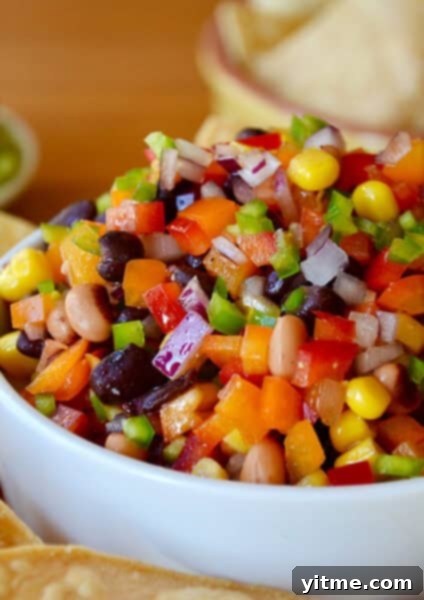 Cowboy caviar in a bowl surrounded by tortilla chips.