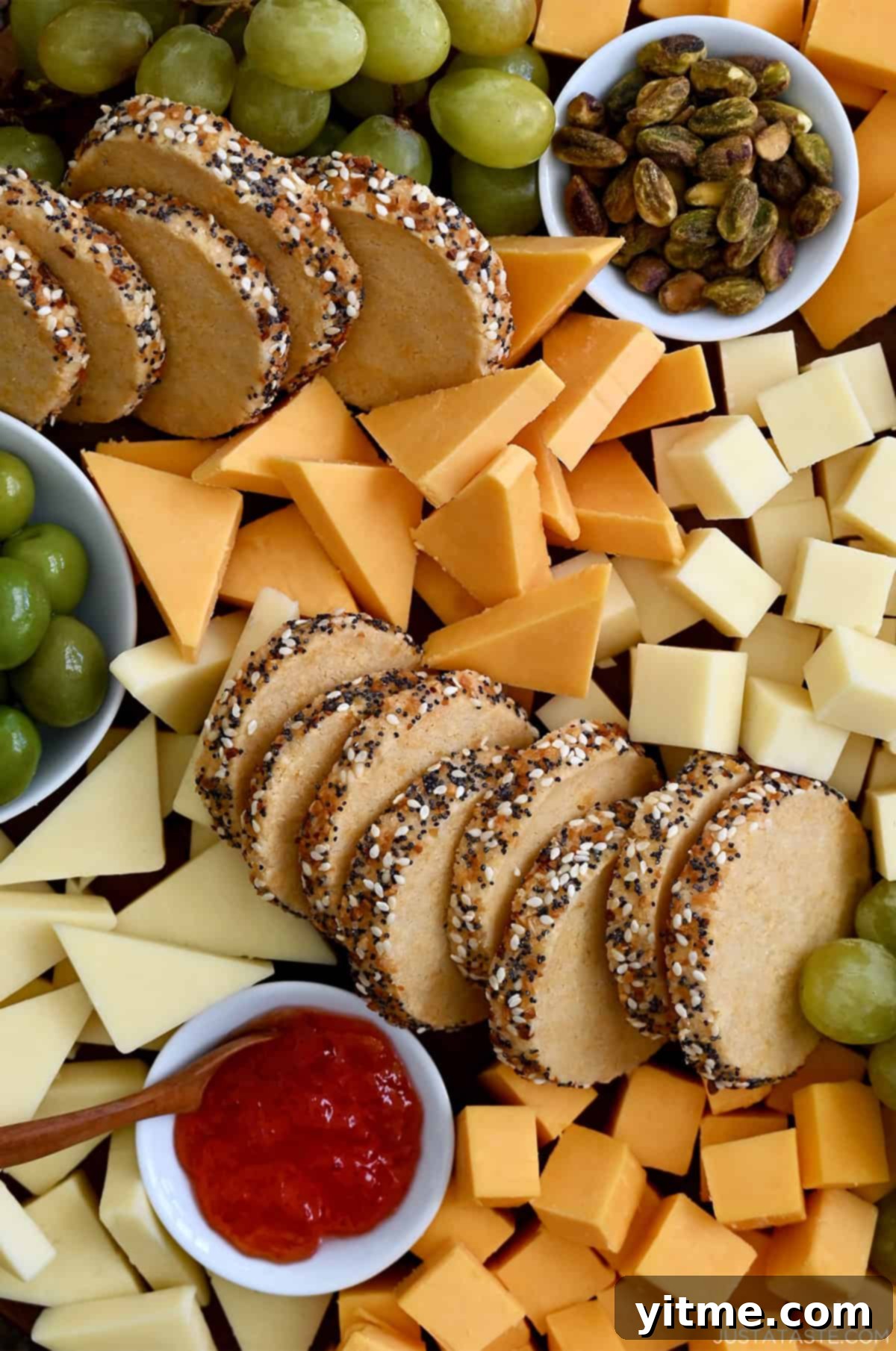 Savory shortbread cookies with everything bagel seasoning amongst cheese and olives.