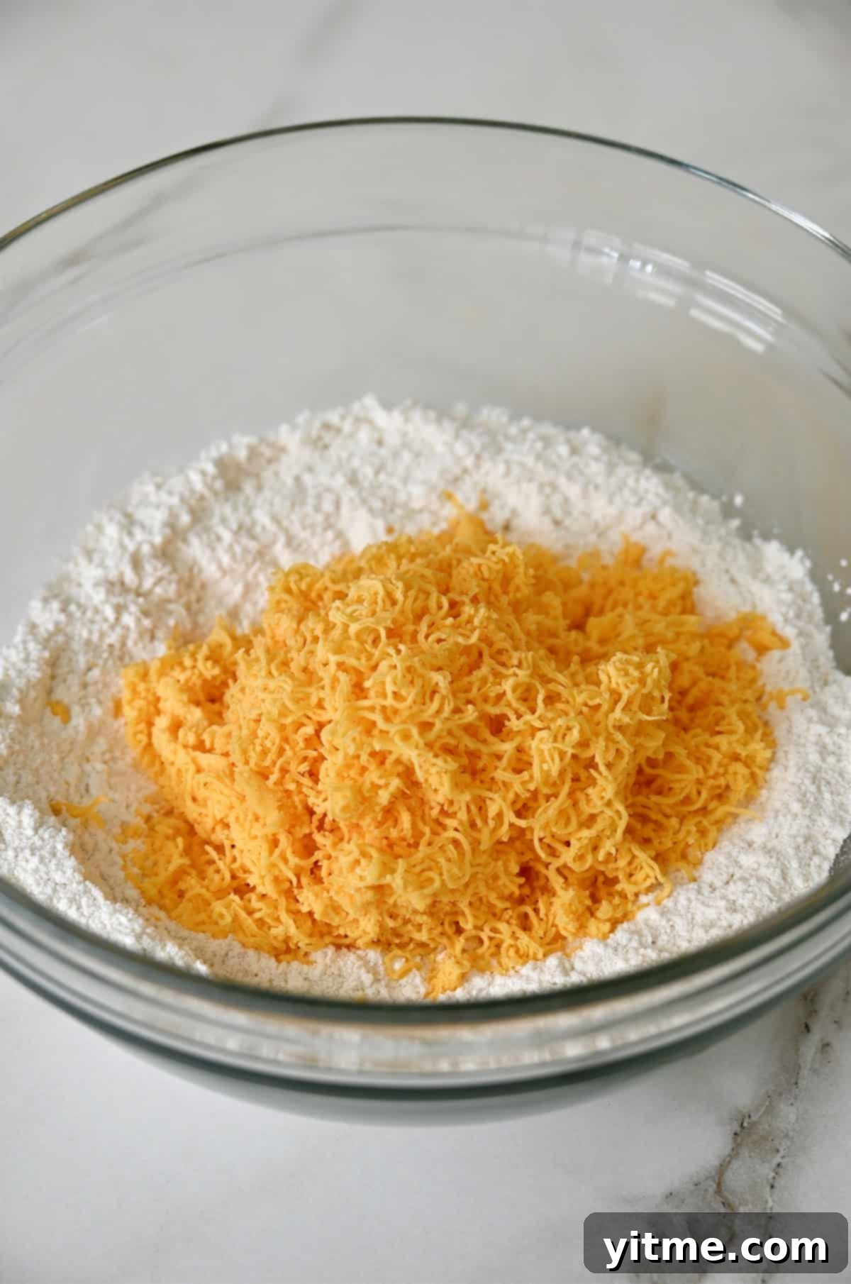 Cheddar cheese atop a flour mixture.