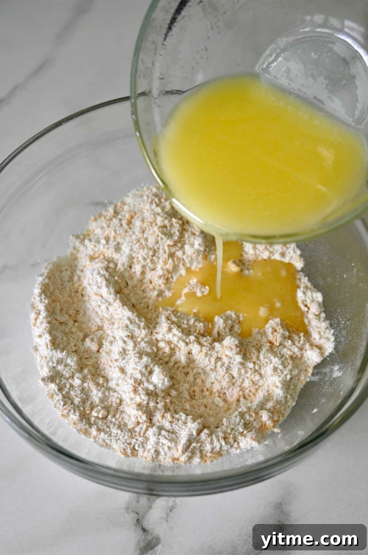 Melted butter being poured atop the mixture.