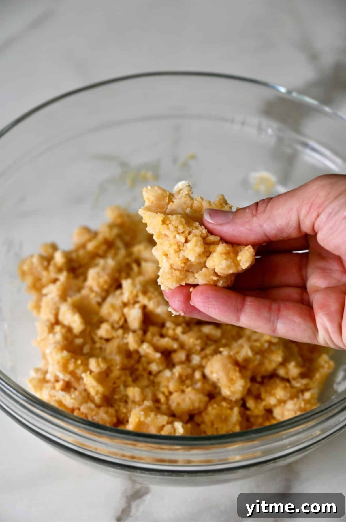 Cheddar dough mixture in hand.