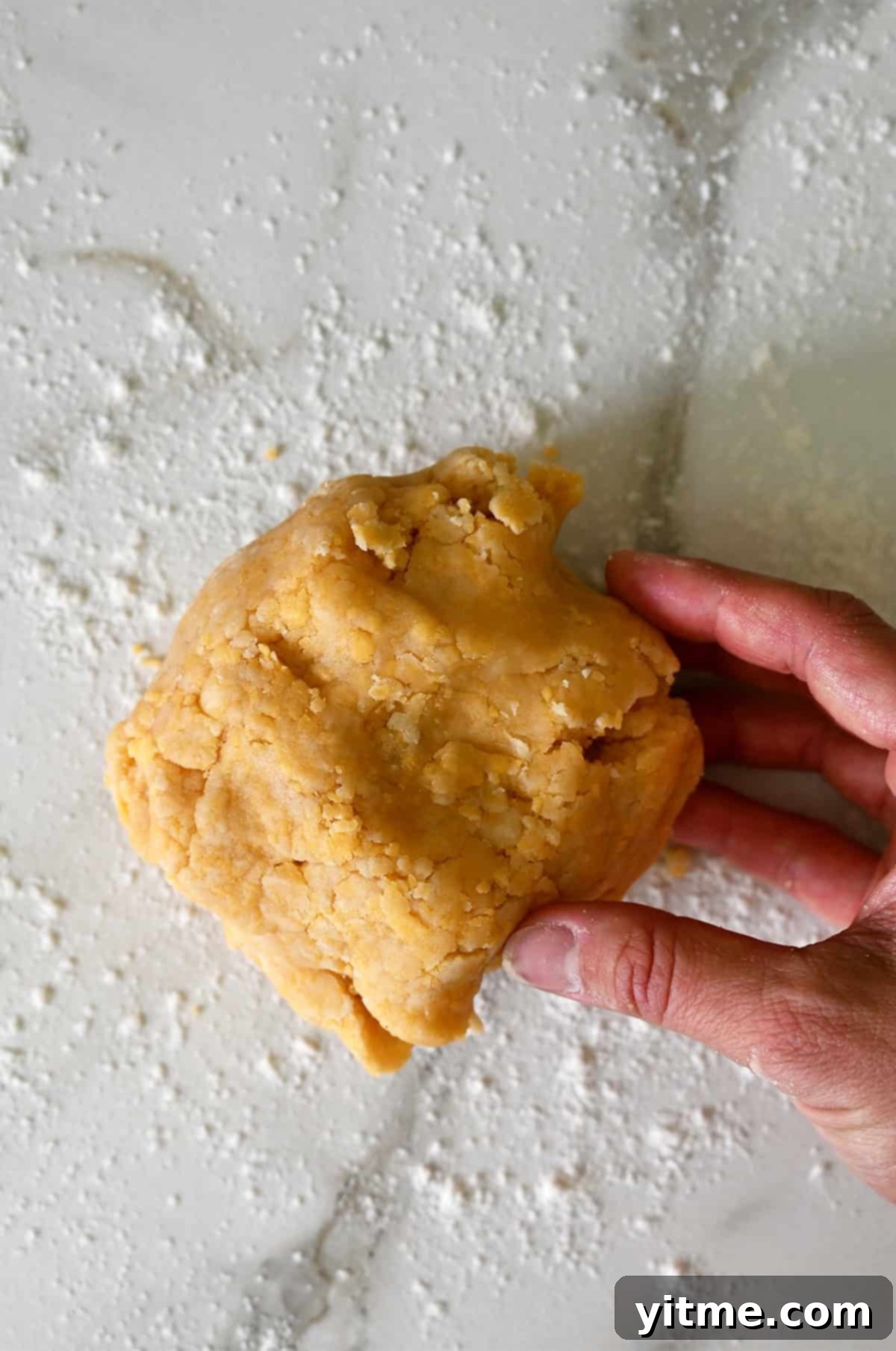 Shaping cookie dough into a ball.