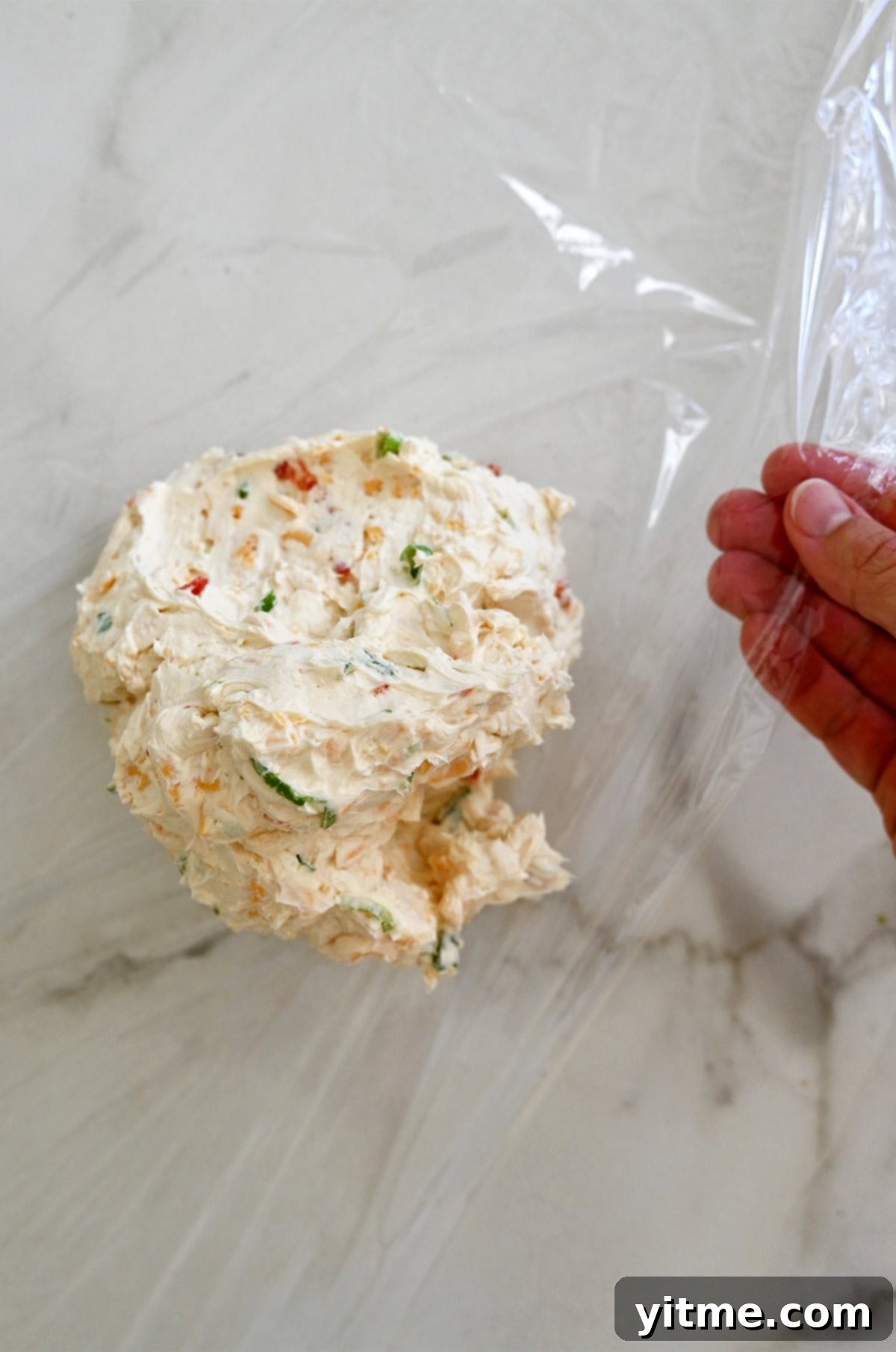 Timeless Cheese Ball 6 Shaping cheese mixture into a round ball.