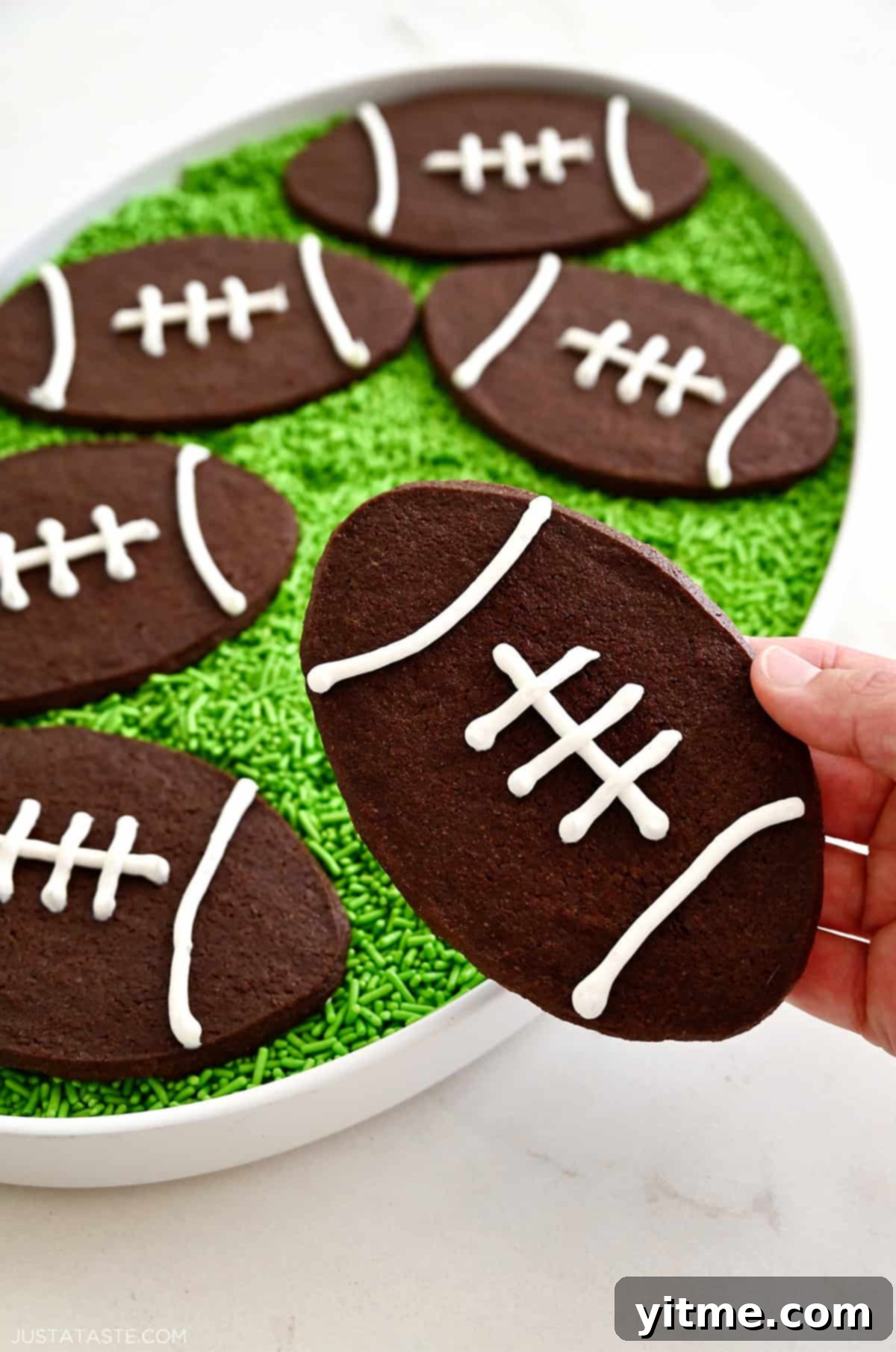 Chocolate football cookies with royal icing laces. Delicious Super Bowl Treats.
