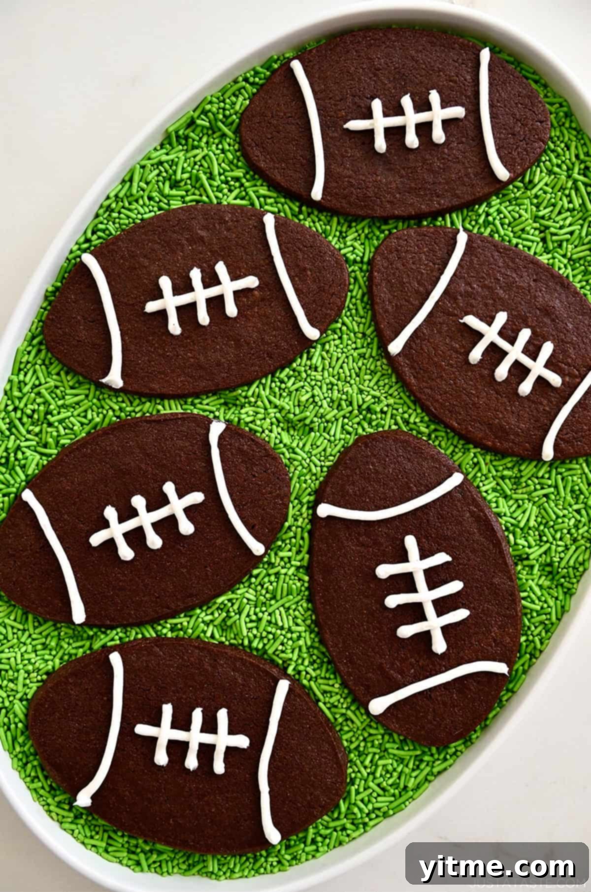 Chocolate football cookies on green sprinkle "grass." Perfect easy treats.