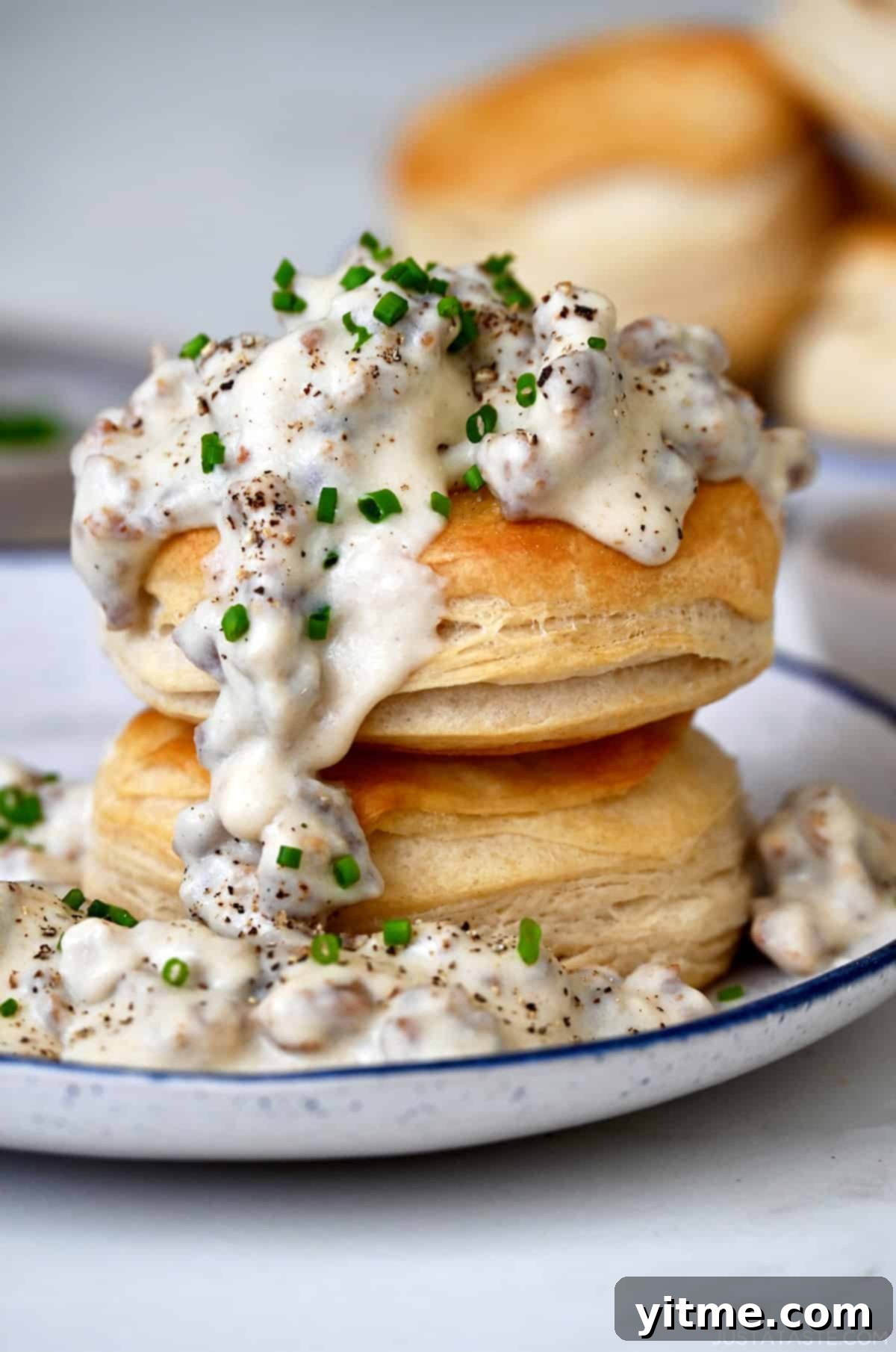 Homemade sausage gravy spooned over biscuits