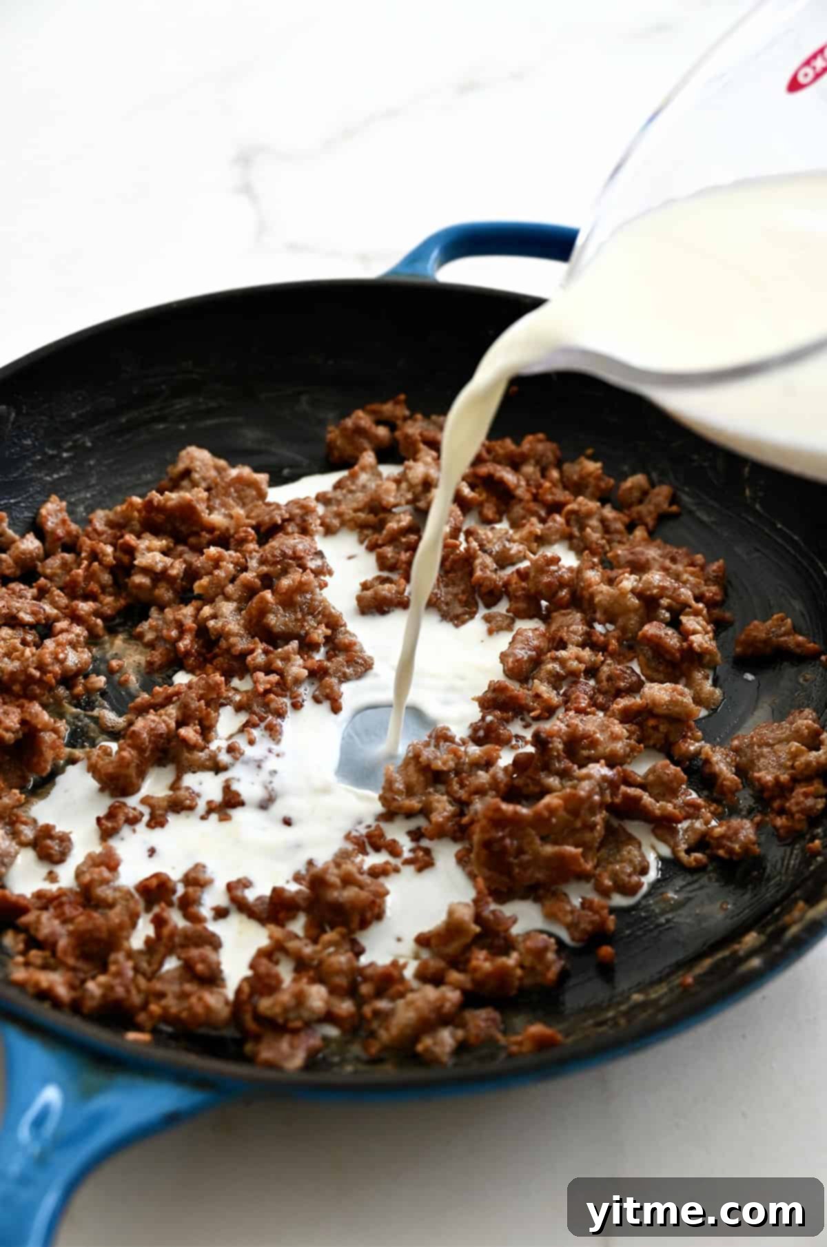 Streaming milk into sausage and flour mixture