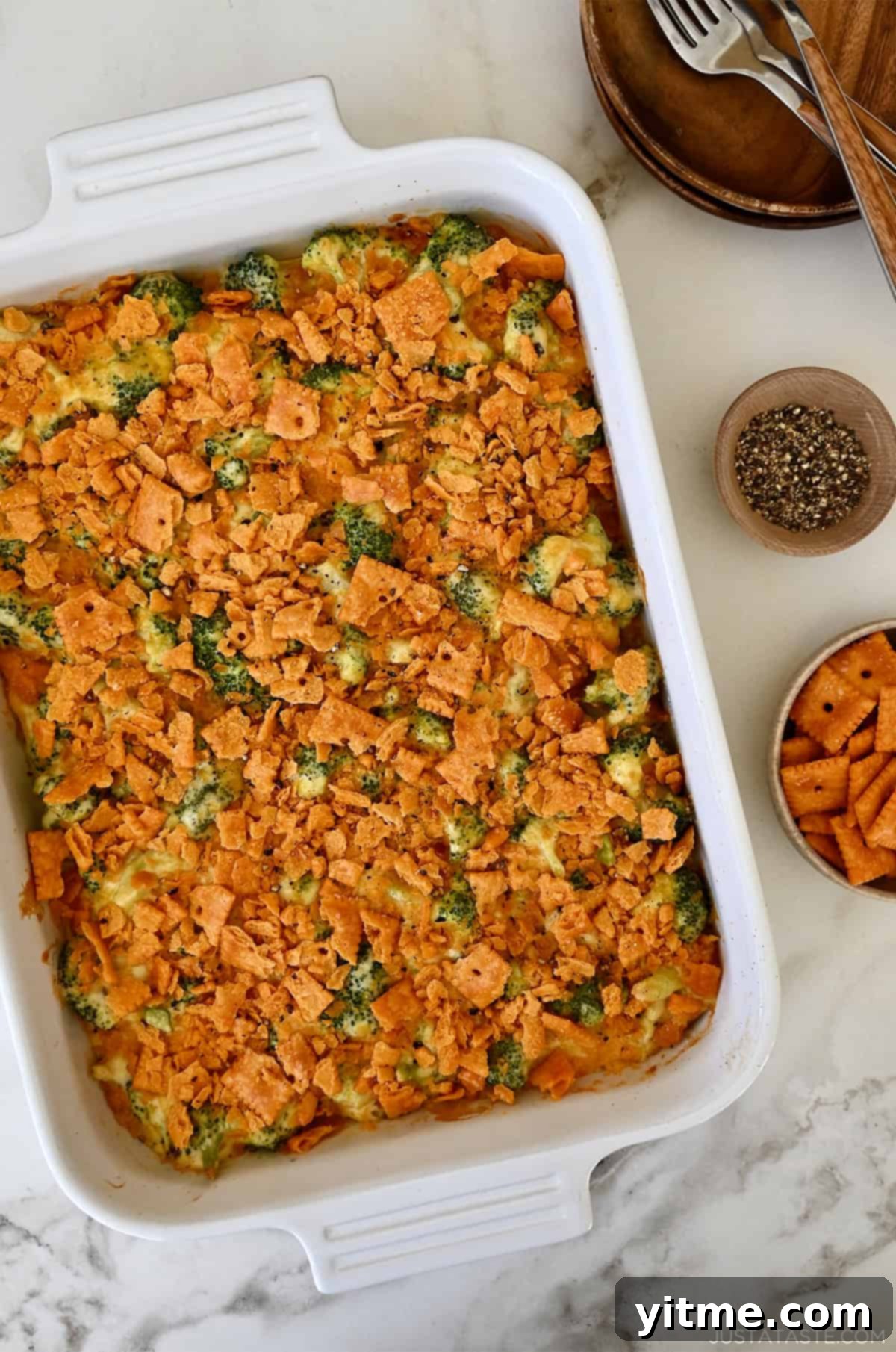 Broccoli cheese casserole with a crushed cheese cracker topping in a 9x13 baking dish. Enjoy the warmth and goodness of this casserole.