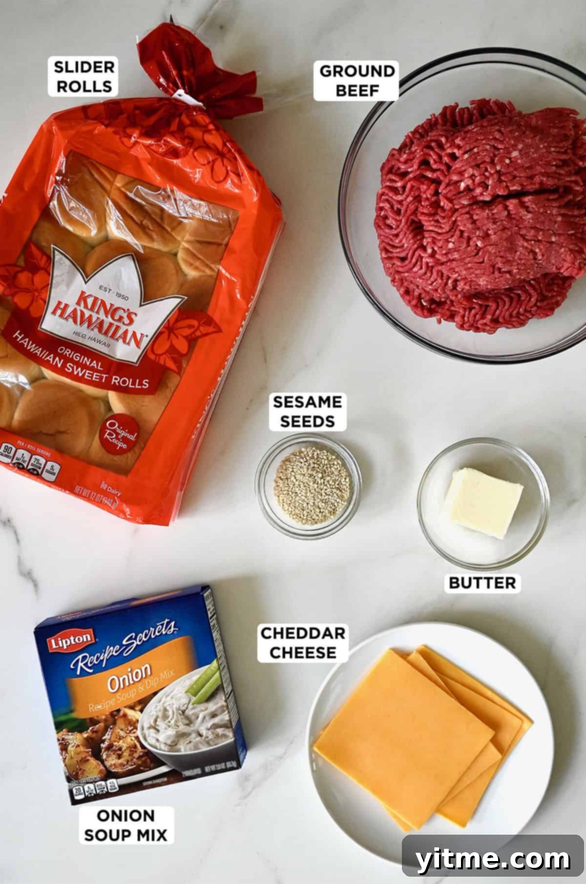 Sliders ingredients: King's Hawaiian Rolls, ground beef, sesame seeds, butter, cheddar cheese and dried onion soup mix. All essential for the best cheeseburger sliders.
