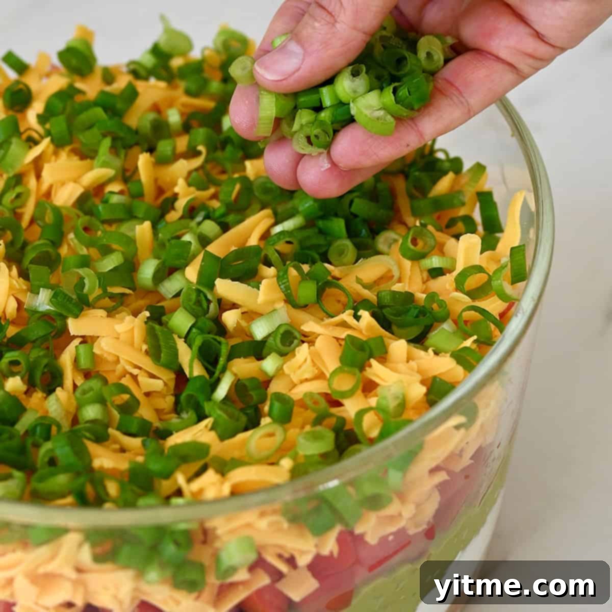 Sprinkling sliced black olives.