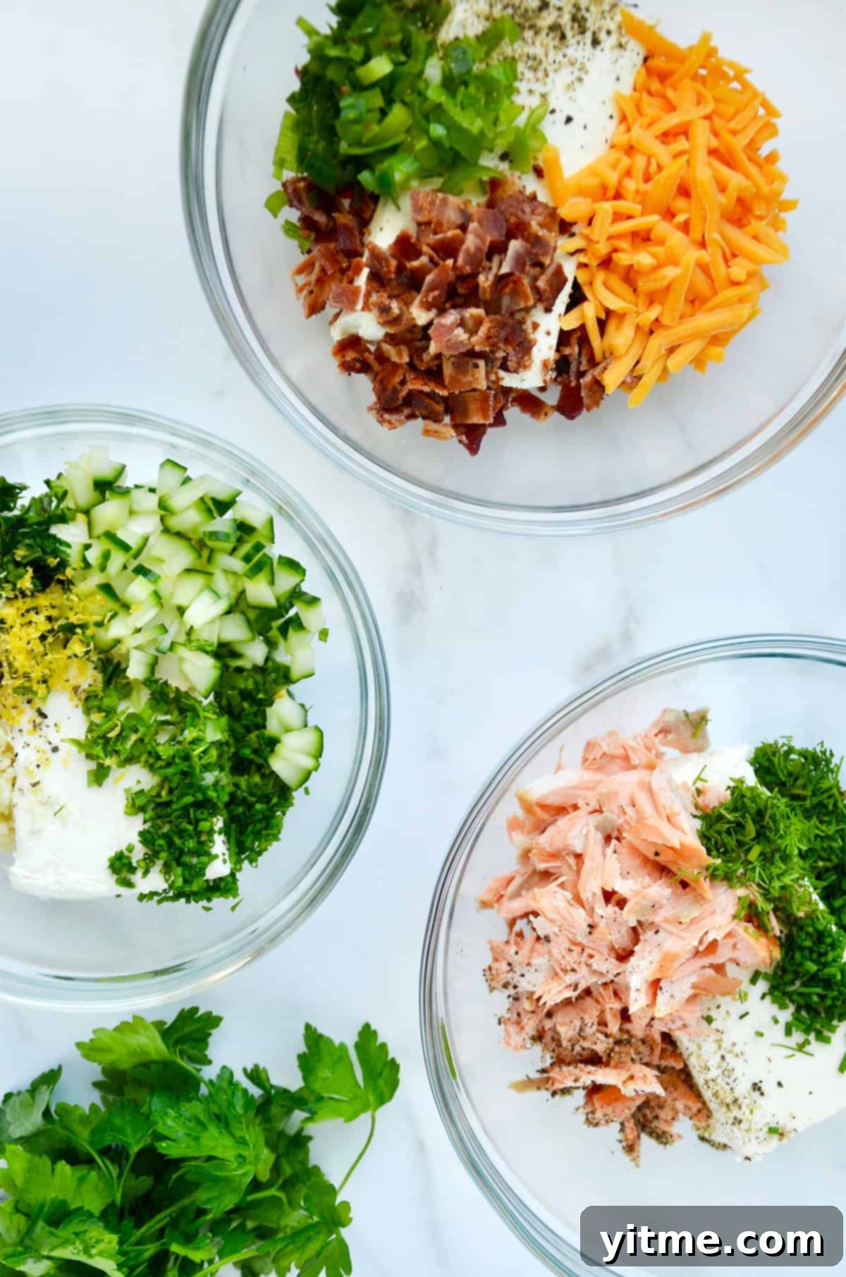 Whip Up Your Own Flavored Cream Cheese 5 Three bowls containing flavored cream cheese: smoked salmon, bacon-scallion and garlic-herb.