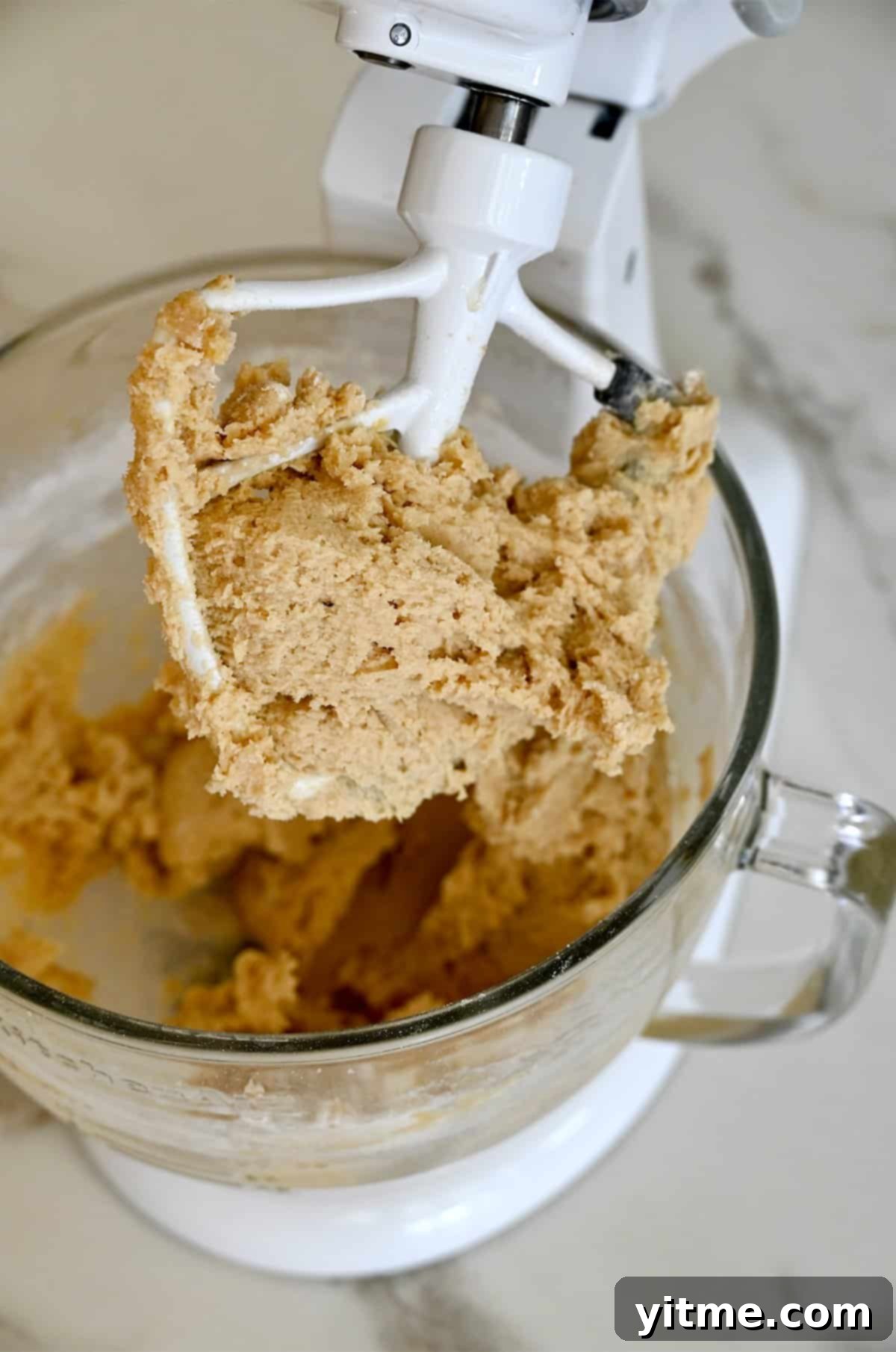 Cookie dough in a stand mixer bowl.