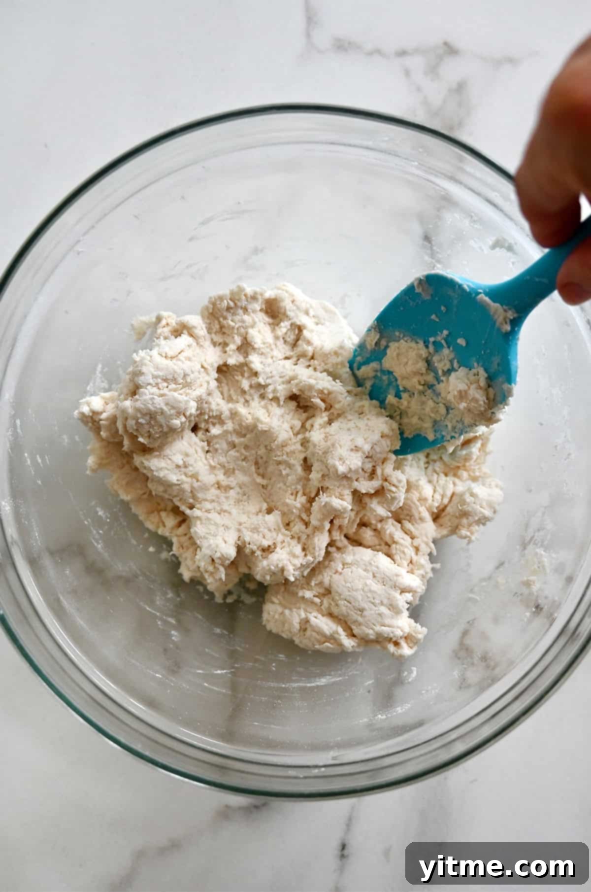 A bowl containing cottage cheese pizza dough.