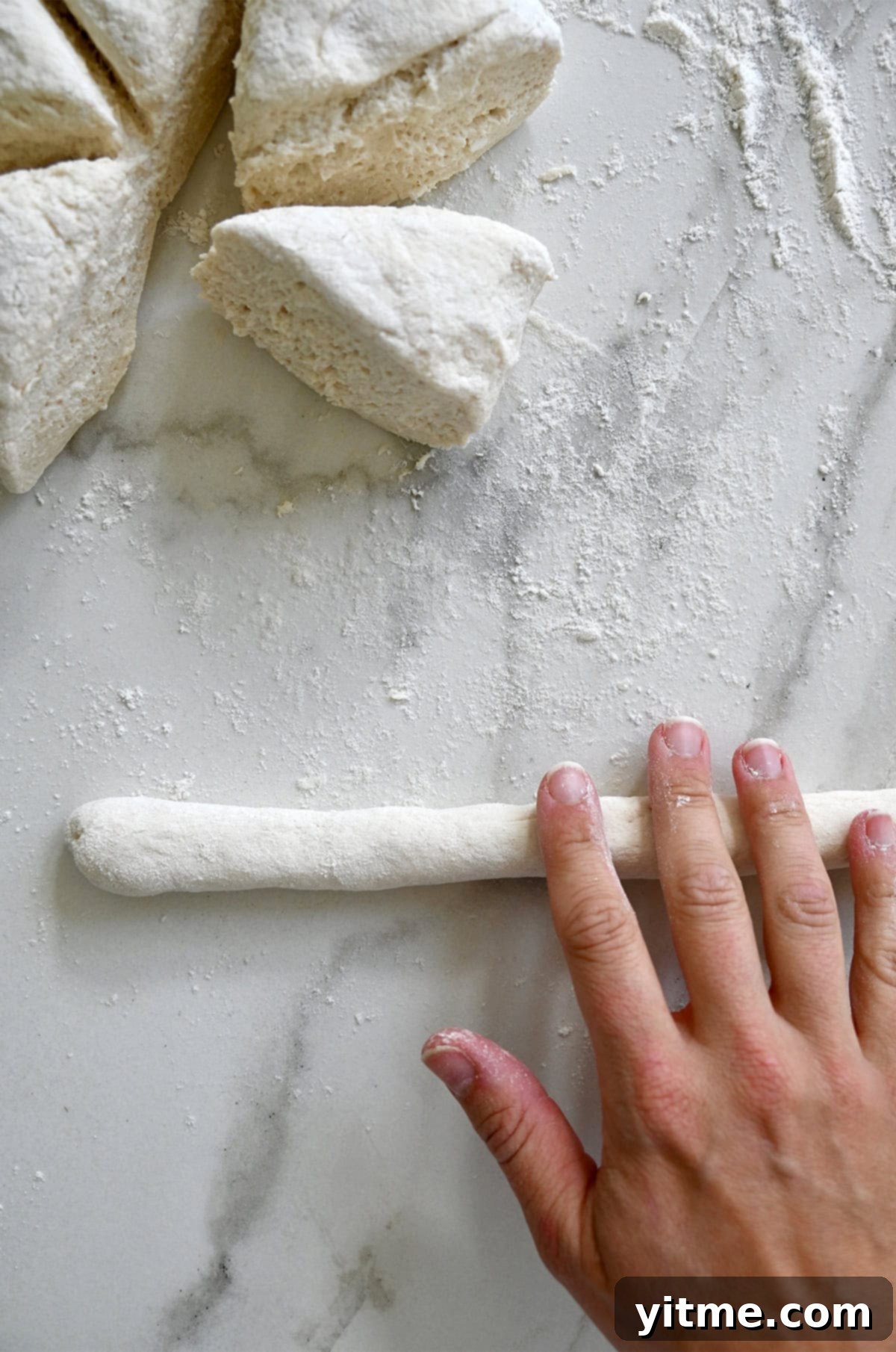 Rolling pretzel dough into a log
