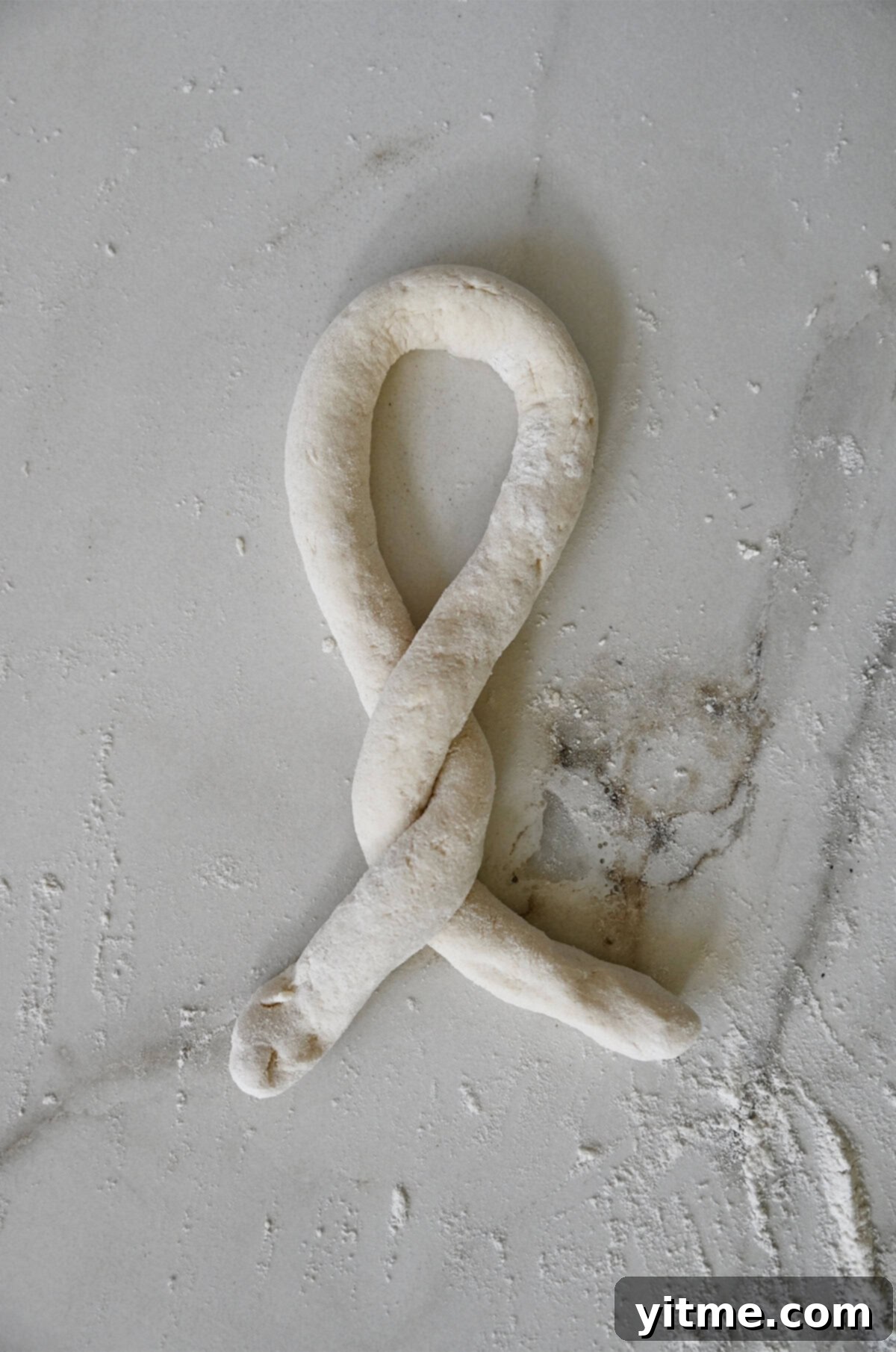 Twisting pretzel dough