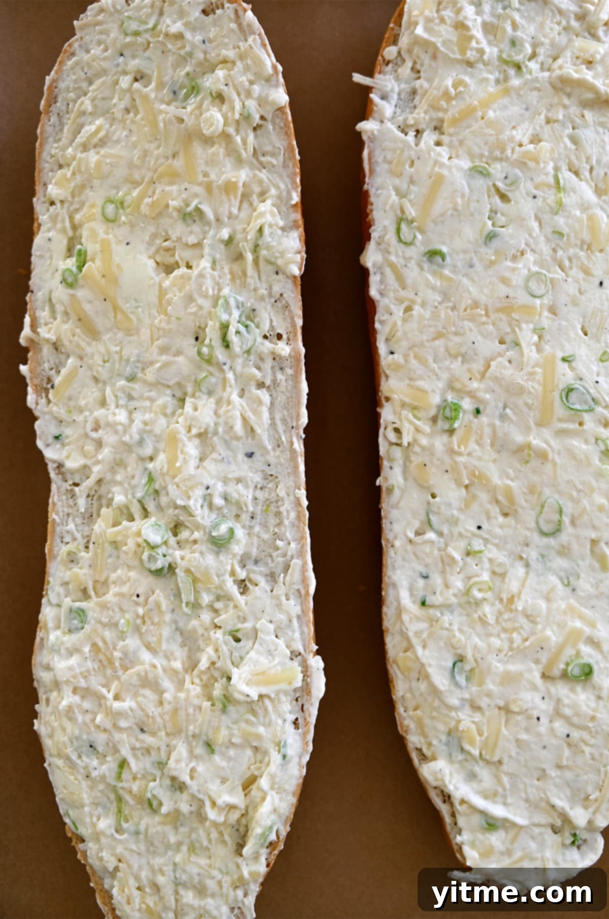 The Unexpected Twist: Cheesy Garlic Bread 5 A French loaf cut in half and slathered with a cheesy garlic butter spread.