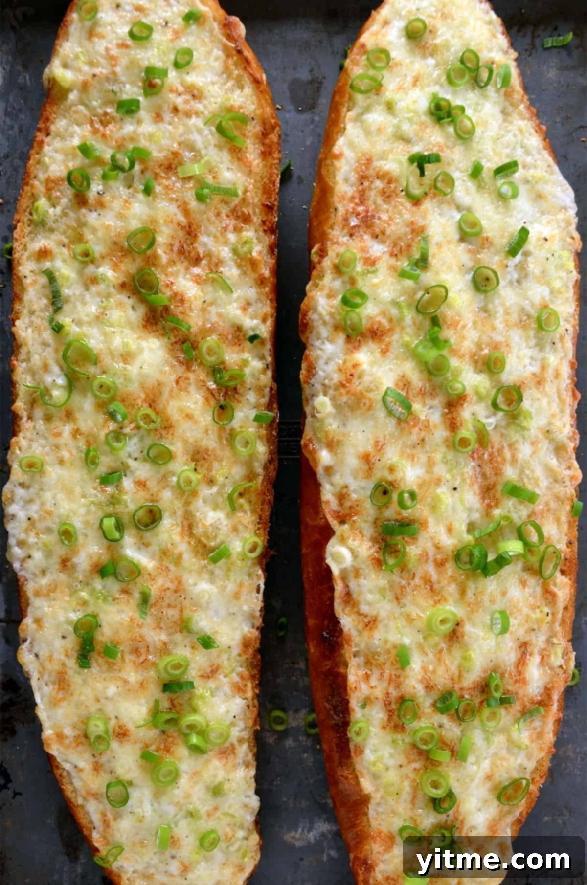 The Unexpected Twist: Cheesy Garlic Bread 6 Two cheesy garlic mayo bread loaves garnished with sliced green onions.