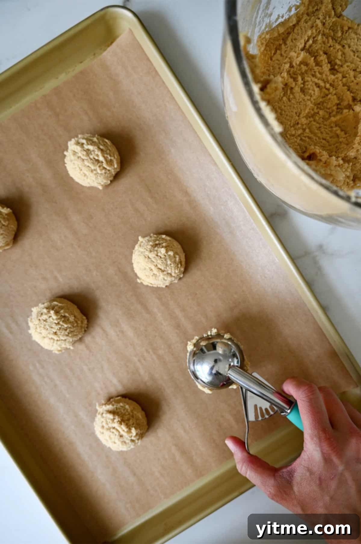 Vanilla Bean Dream Cookies 8 Using a cookie scoop to place chipless cookie dough balls onto a parchment paper-lined baking sheet. Perfectly portioned dough ready for the oven.