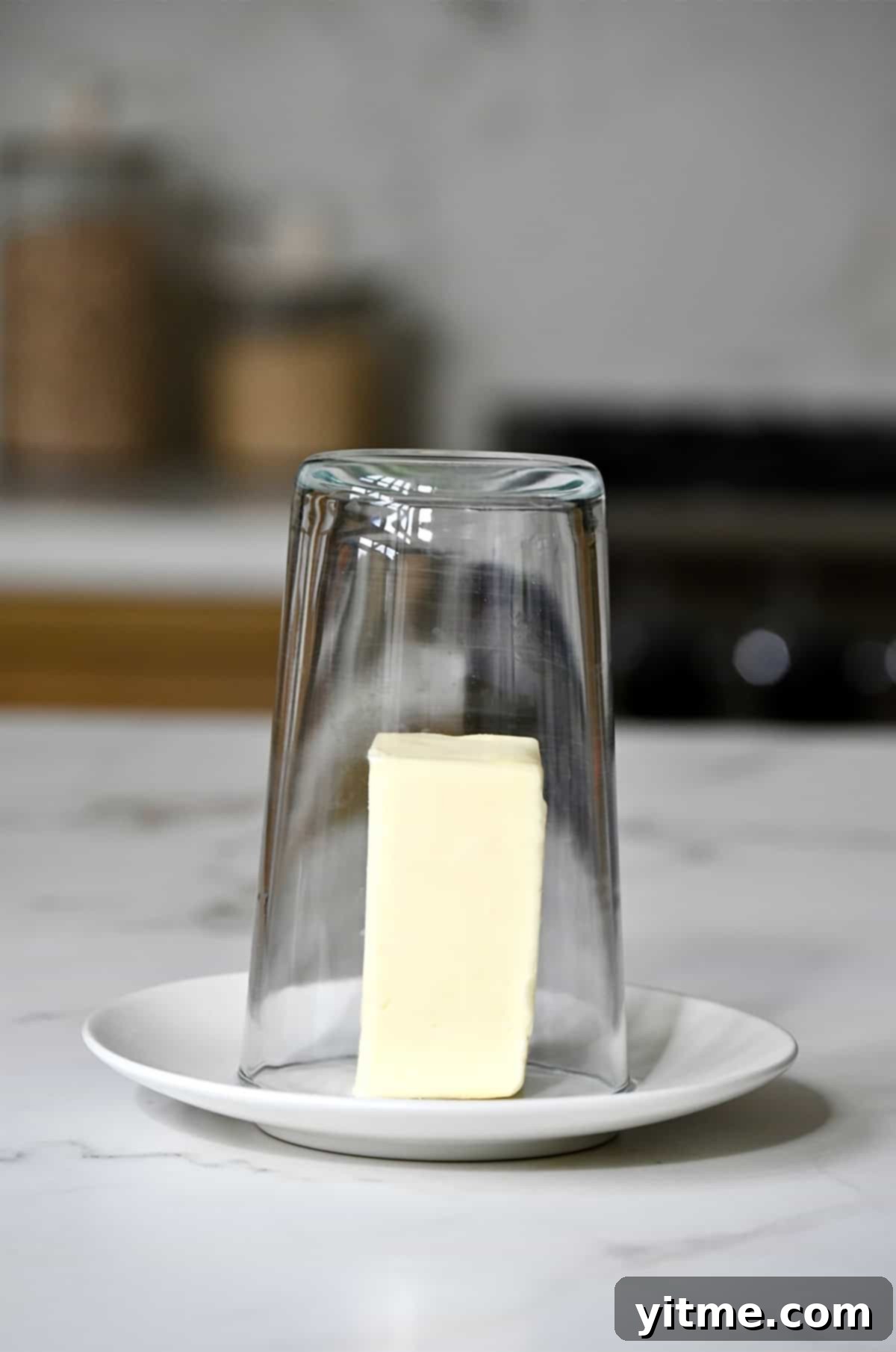 Using a hot glass to soften butter quickly.