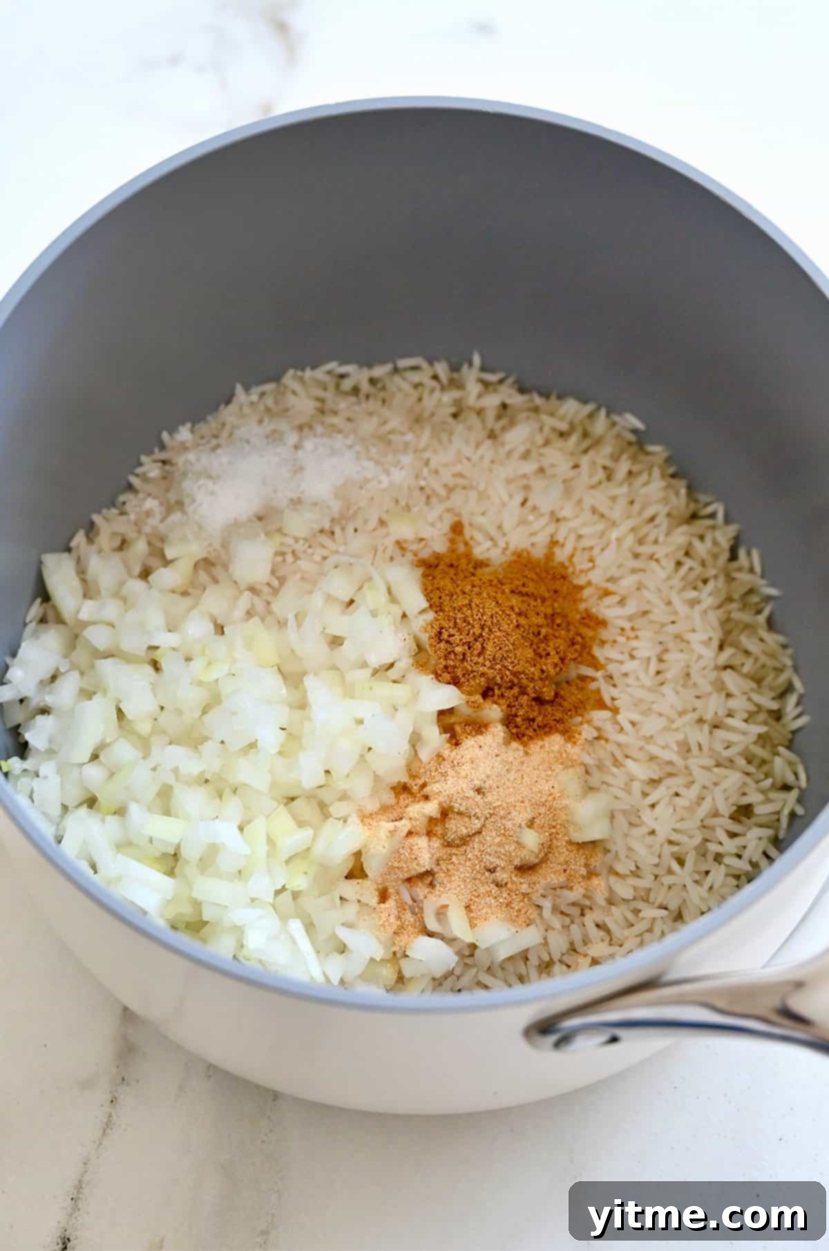 Vibrant Mexican Rice: A Flavorful Fiesta 5 Toasting rice with spices and onions