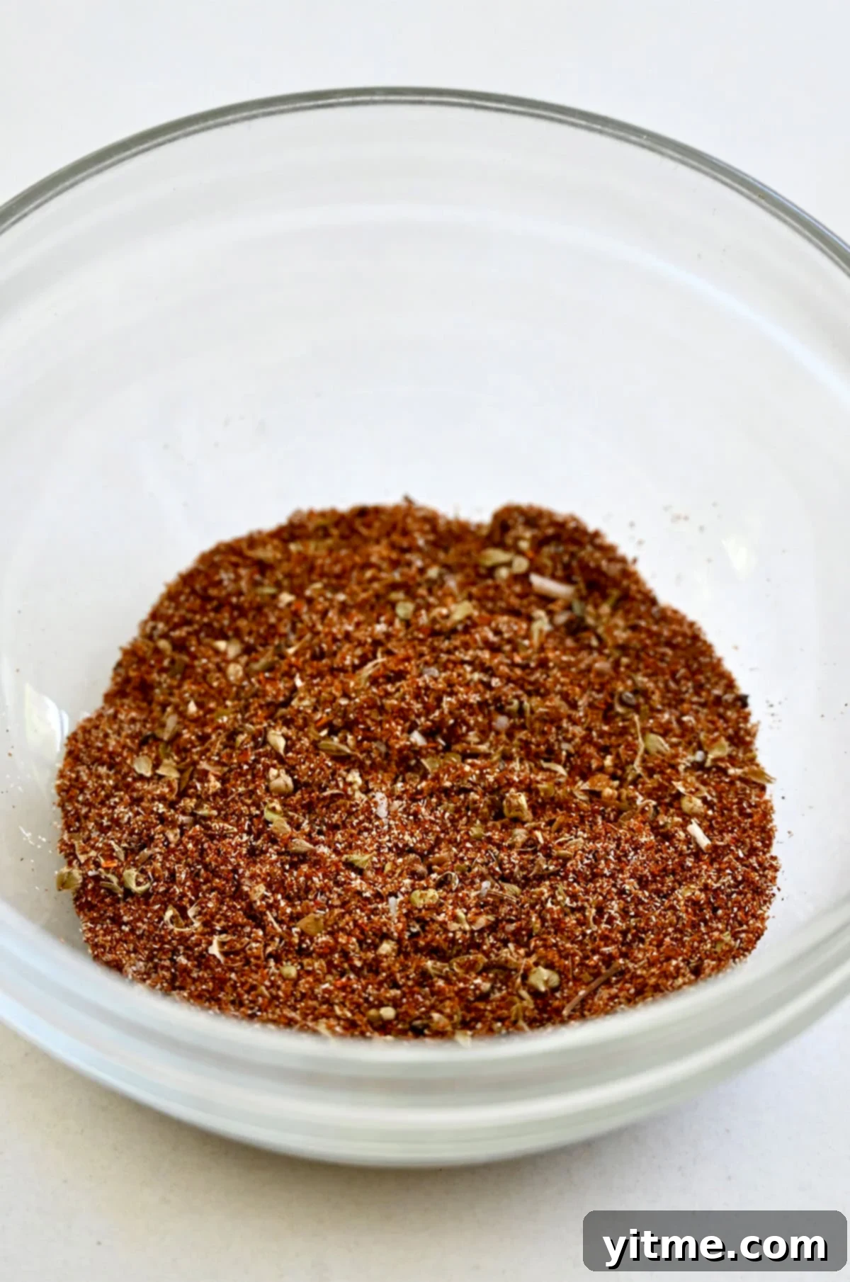 Homemade taco seasoning in a glass bowl.