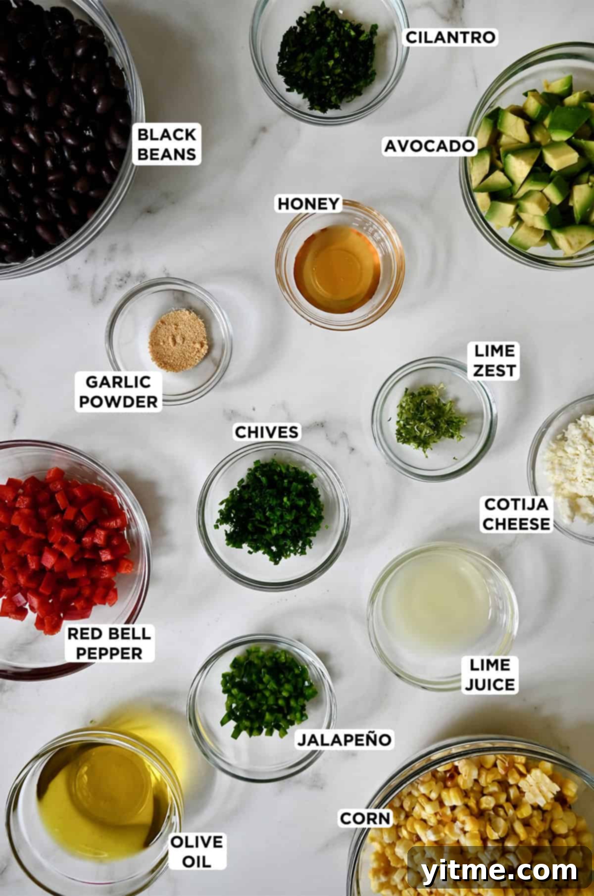 Black bean corn salad ingredients in glass bowls.