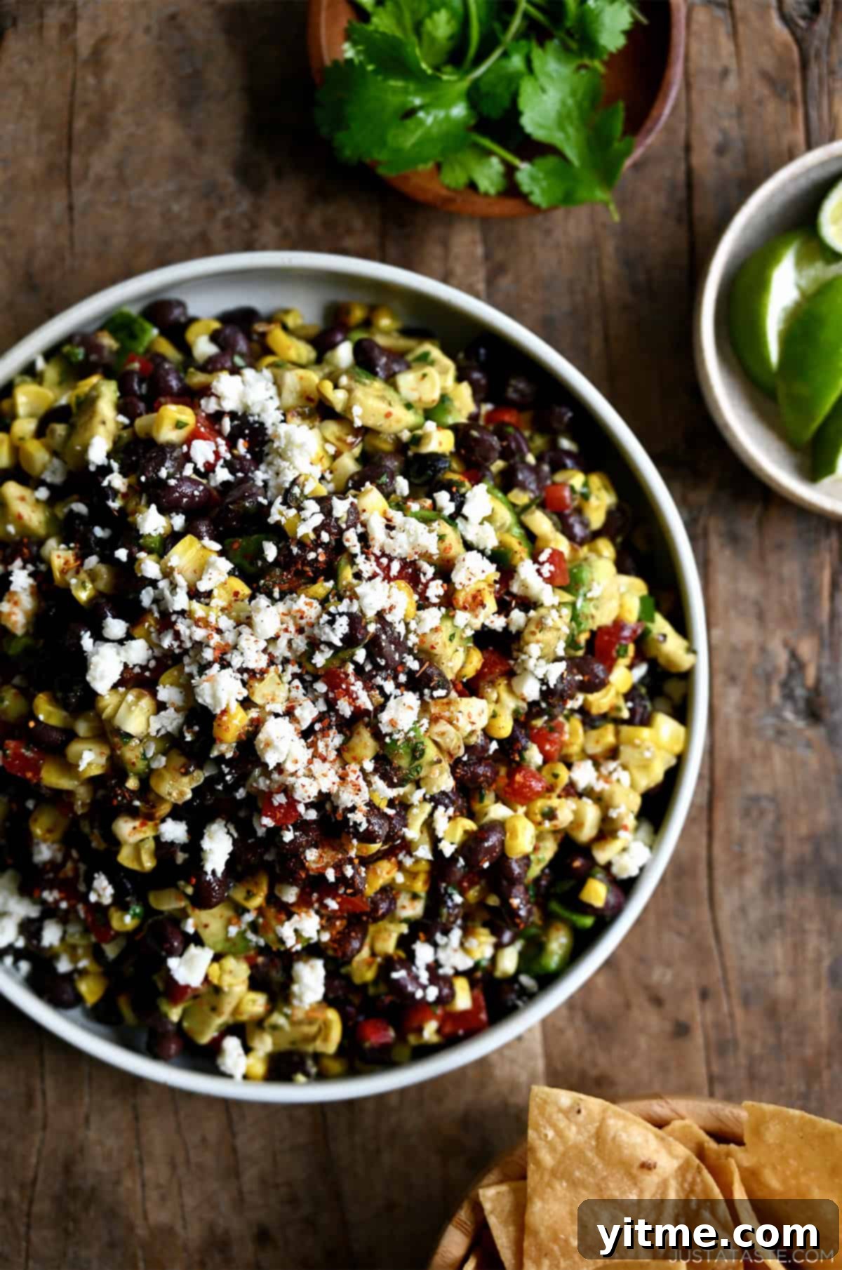 Black bean and corn salad garnished with Cojita cheese, served with tortilla chips.