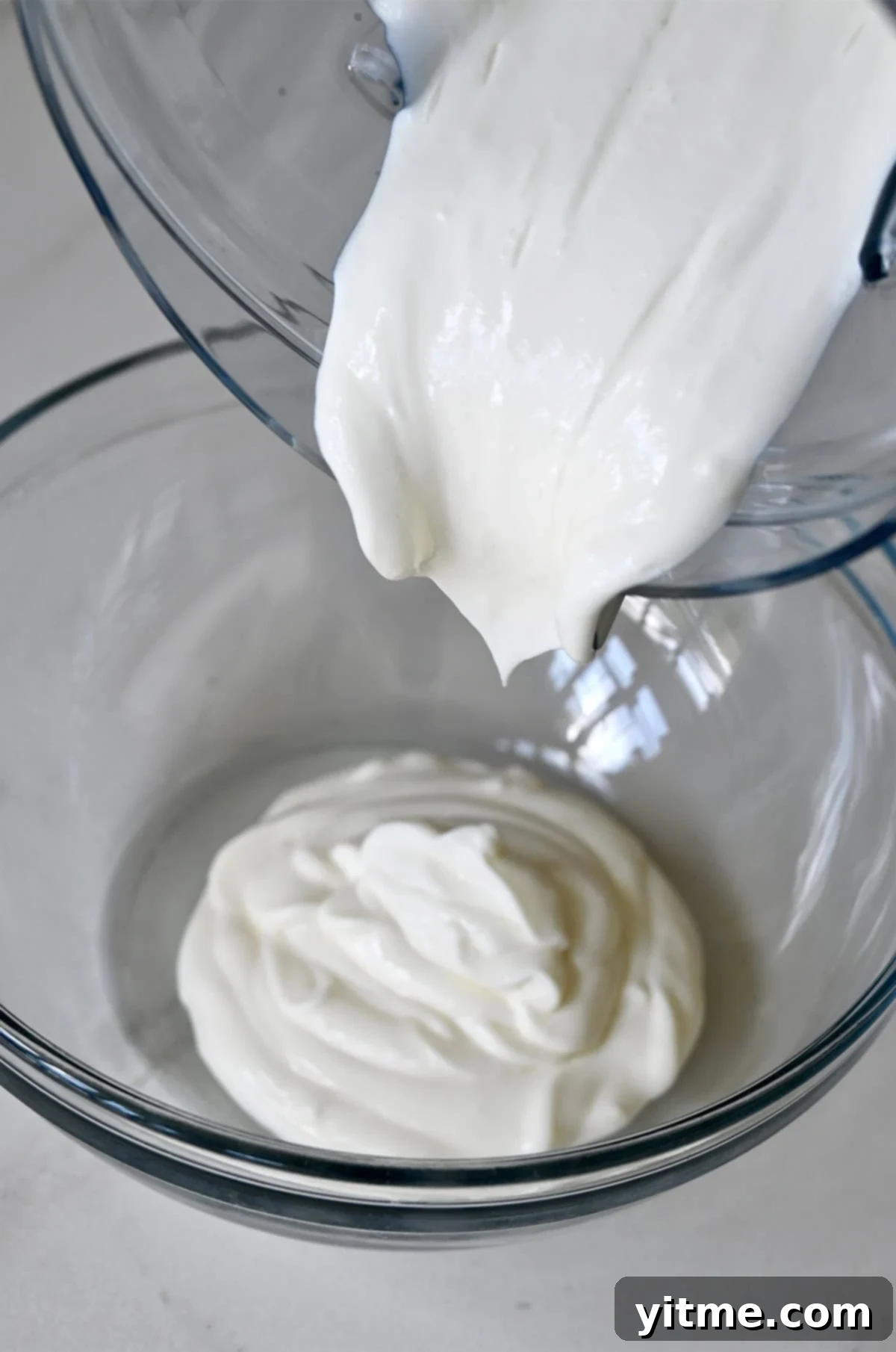 Pouring blended cottage cheese into a bowl