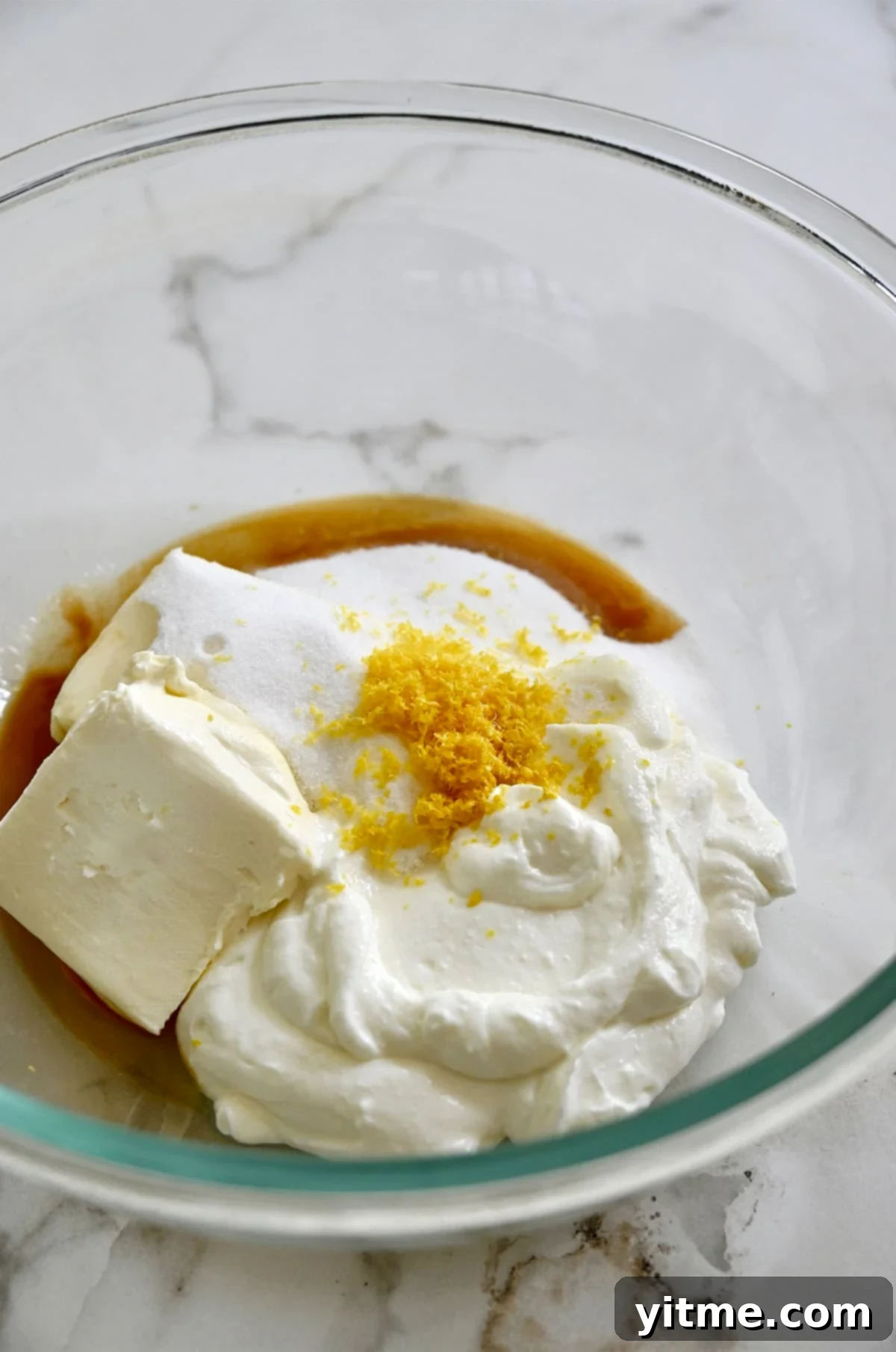Cheesecake filling ingredients in a bowl