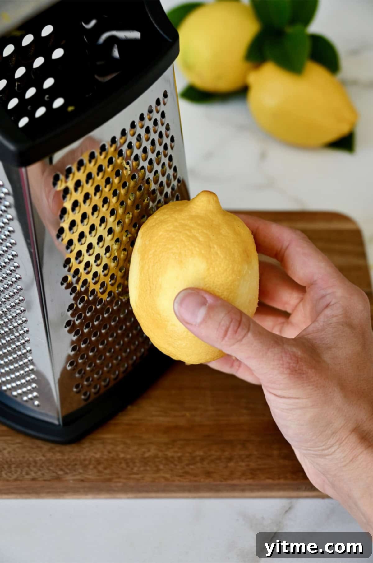 Zesting Lemons: A Citrus Twist Guide 4 Step-by-step guide to zesting a lemon using the small holes of a box grater.