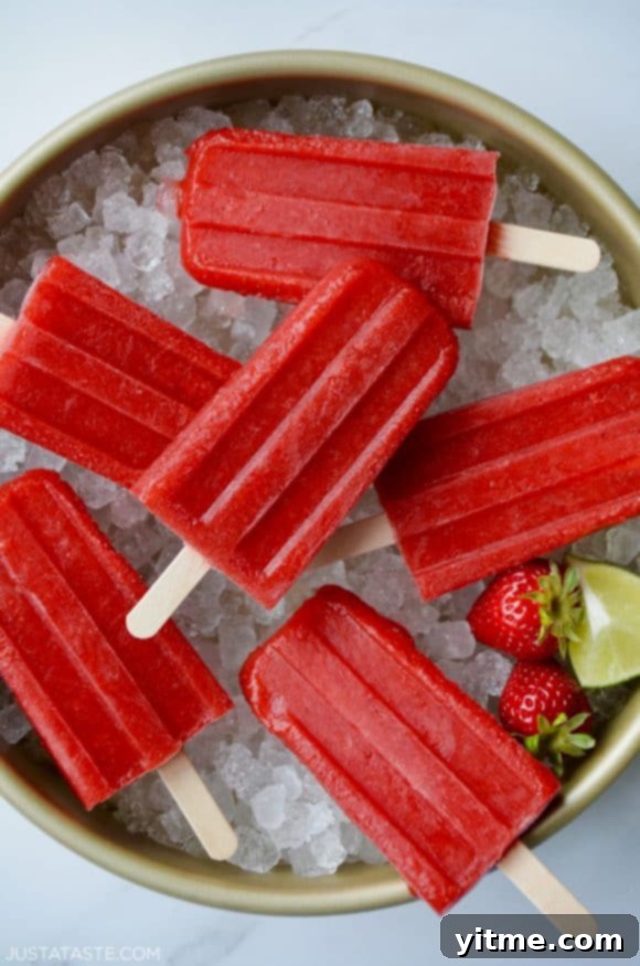 Top down view of Strawberry Margarita Popsicles on ice