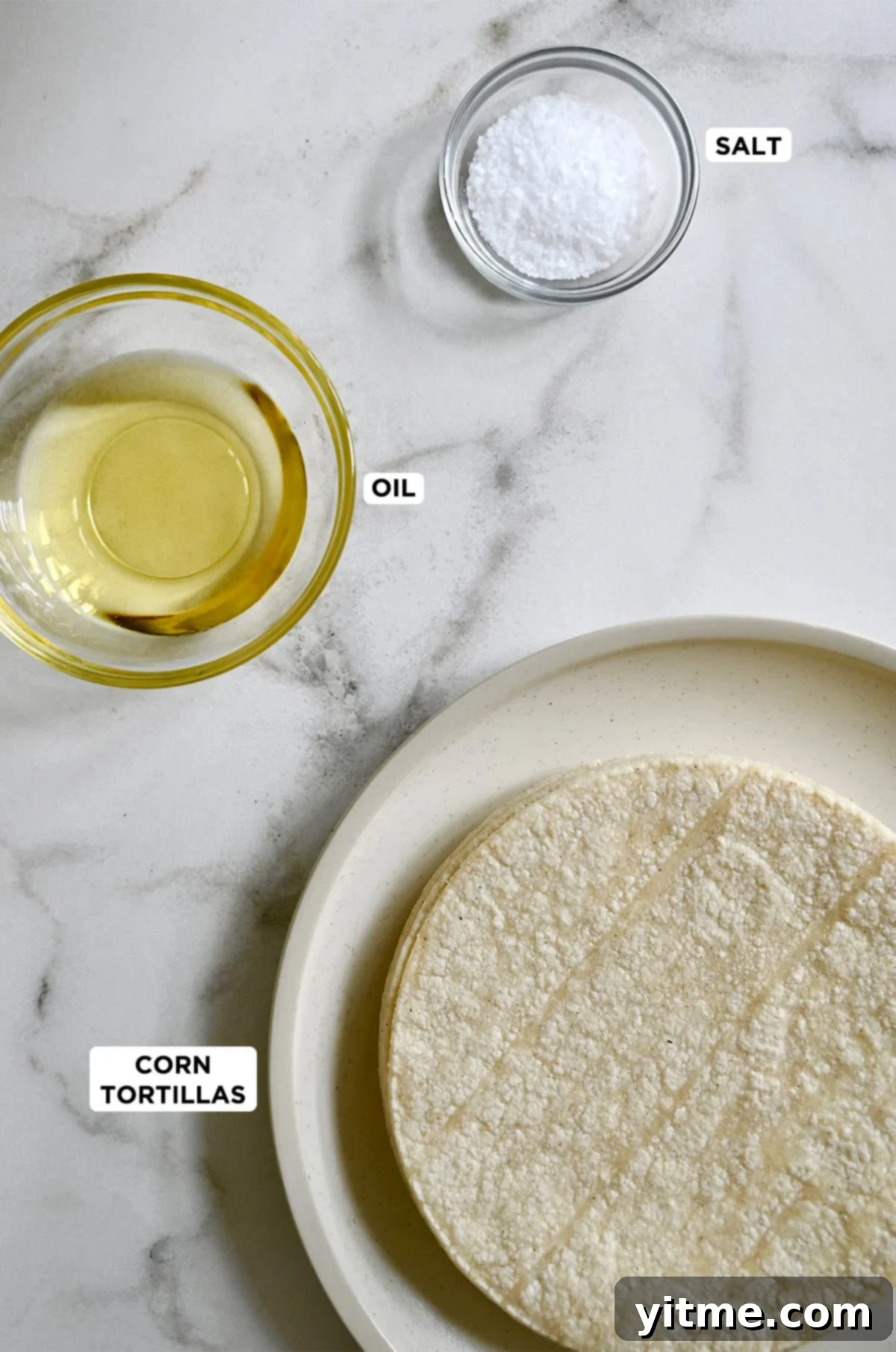 Crispy Homemade Tortilla Chips: Two Ways to Deliciousness 3 Ingredients for homemade tortilla chips: corn tortillas, oil, and salt.