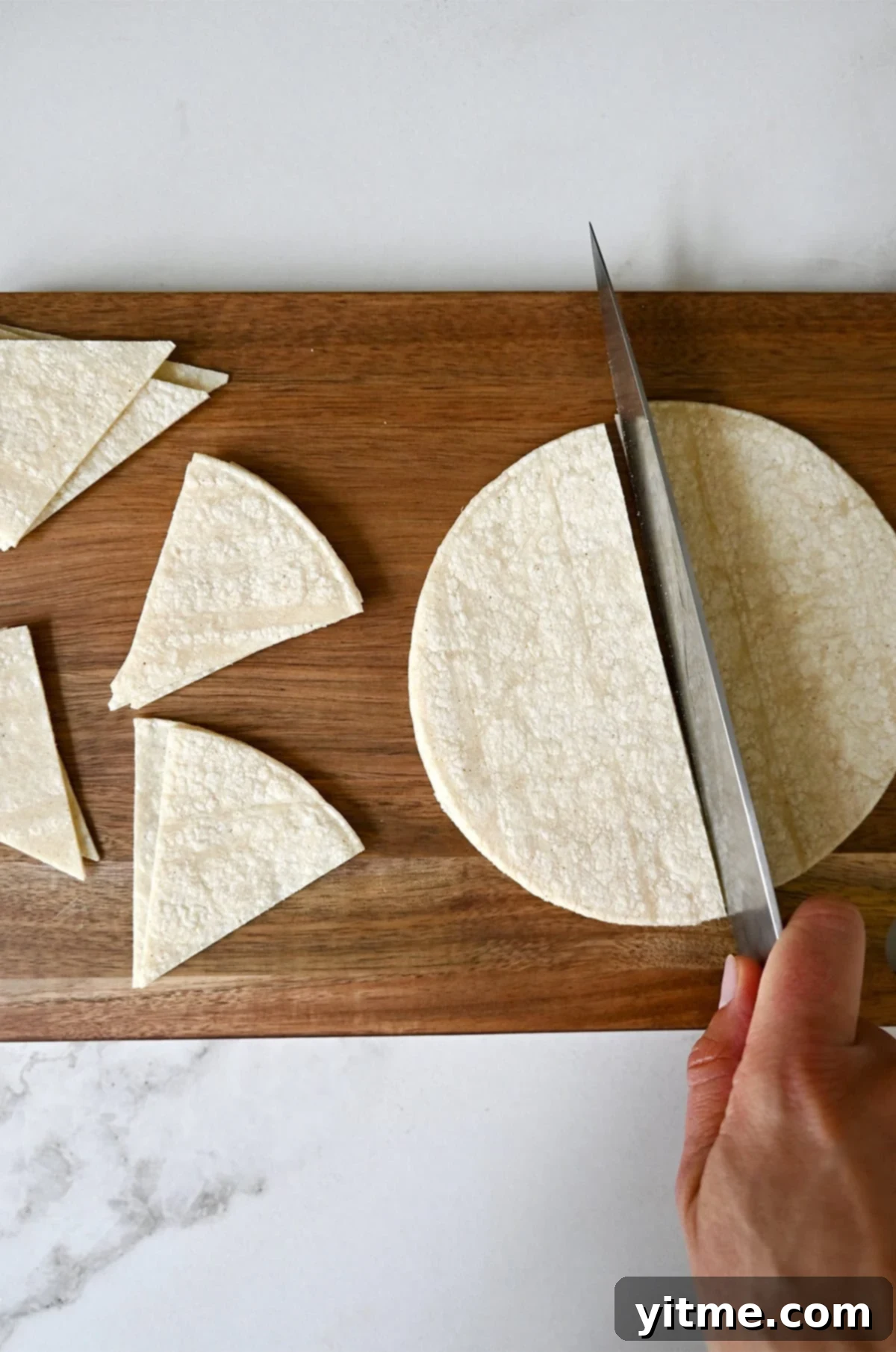 Crispy Homemade Tortilla Chips: Two Ways to Deliciousness 4 Cutting corn tortillas into wedges with a sharp knife.