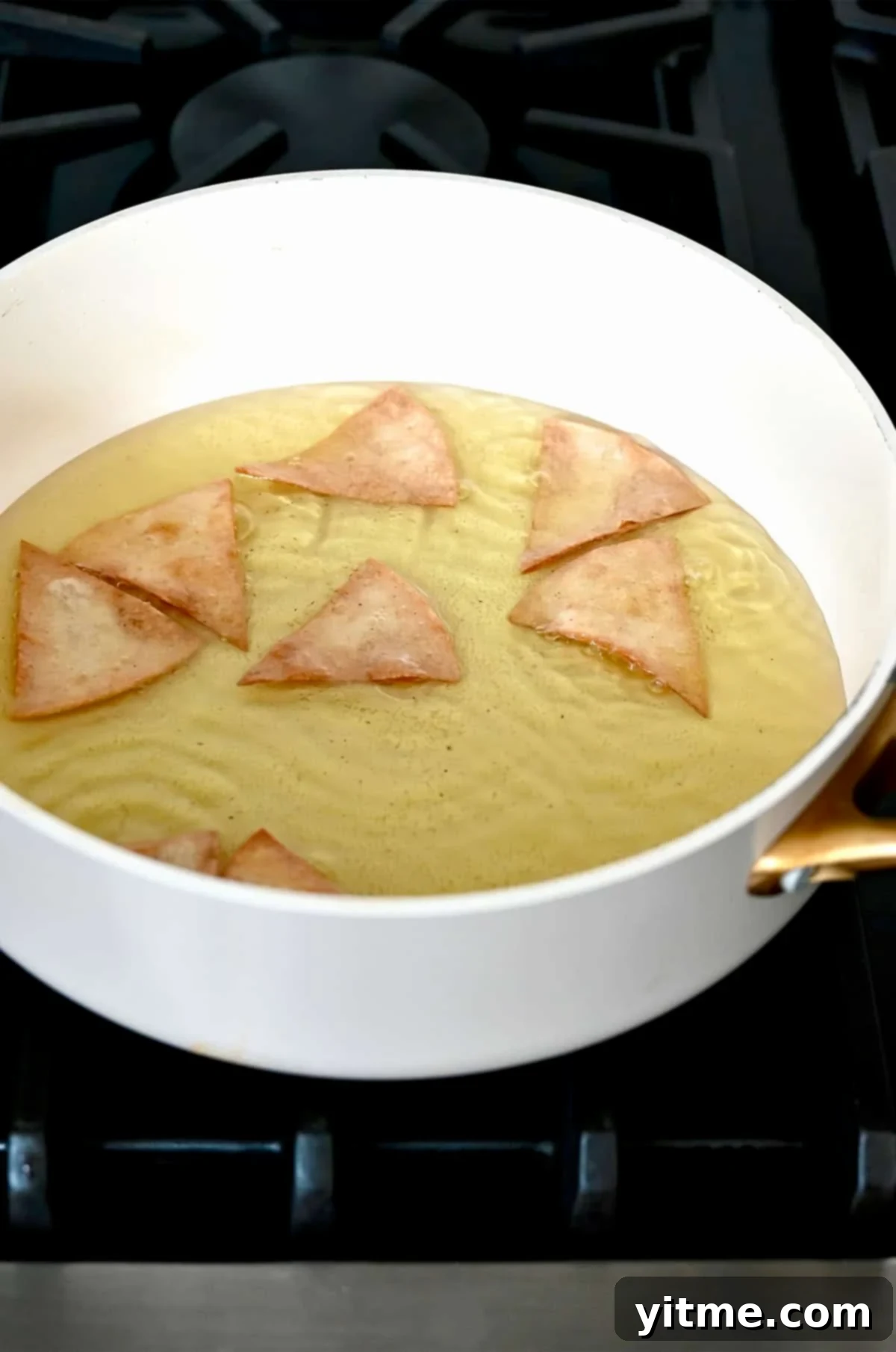 Crispy Homemade Tortilla Chips: Two Ways to Deliciousness 5 Frying tortilla chips in hot oil.