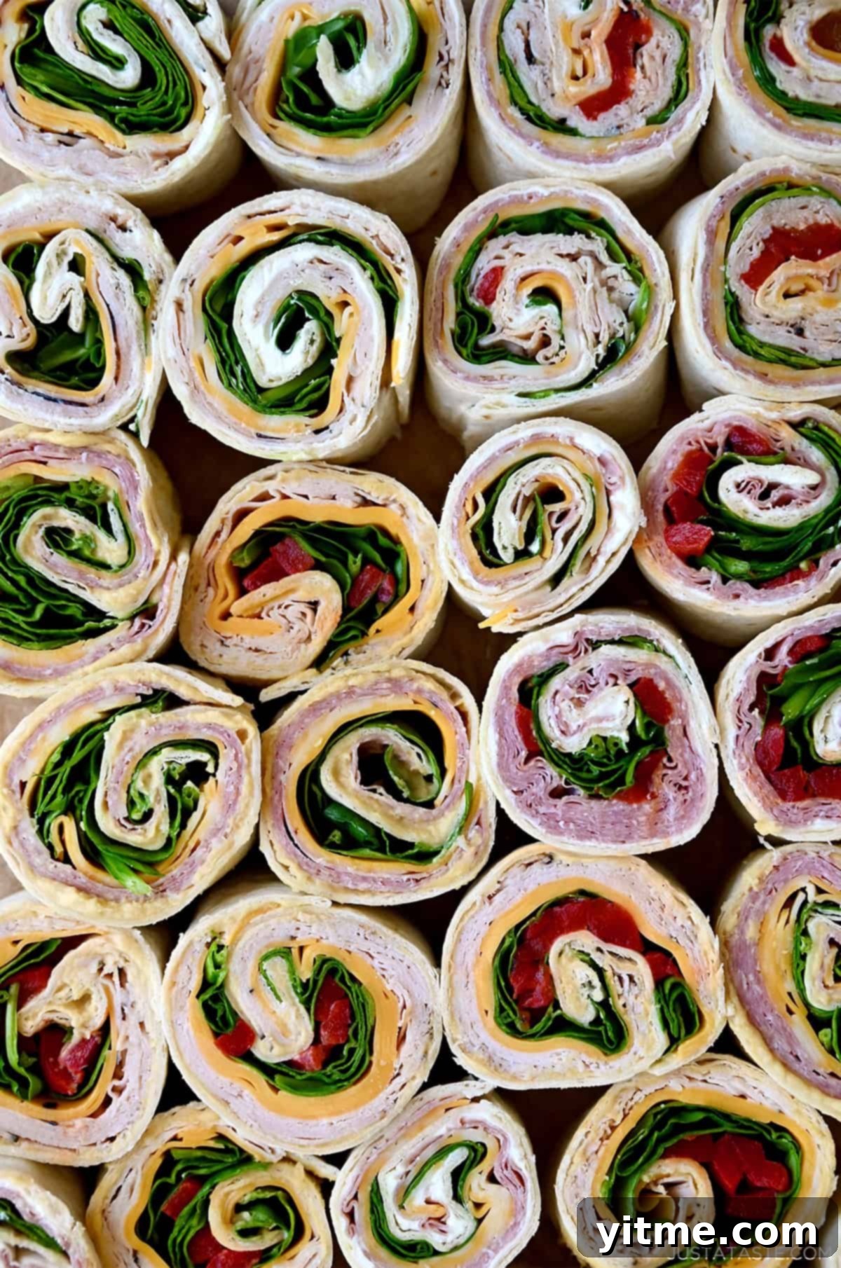 Swirl Sandwiches 2 Variety of pinwheel sandwiches: ham and cheese, turkey and spinach, and salami pinwheel sandwiches.