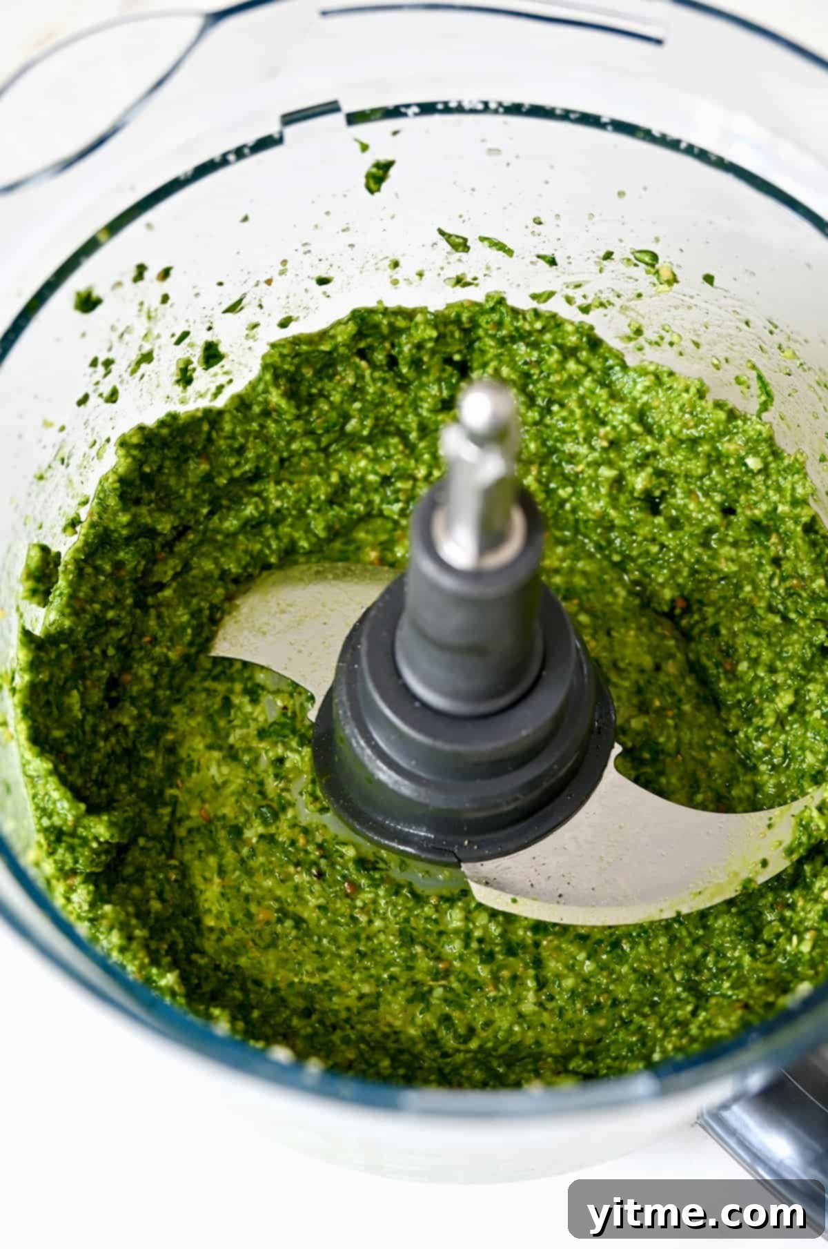 Simple Homemade Basil Pesto 5 Blended basil pesto in a food processor, ready to be used.