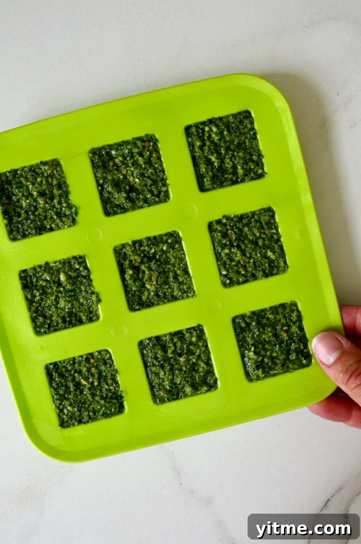 Simple Homemade Basil Pesto 8 Freezing pesto in a silicone tray, perfect for single servings.