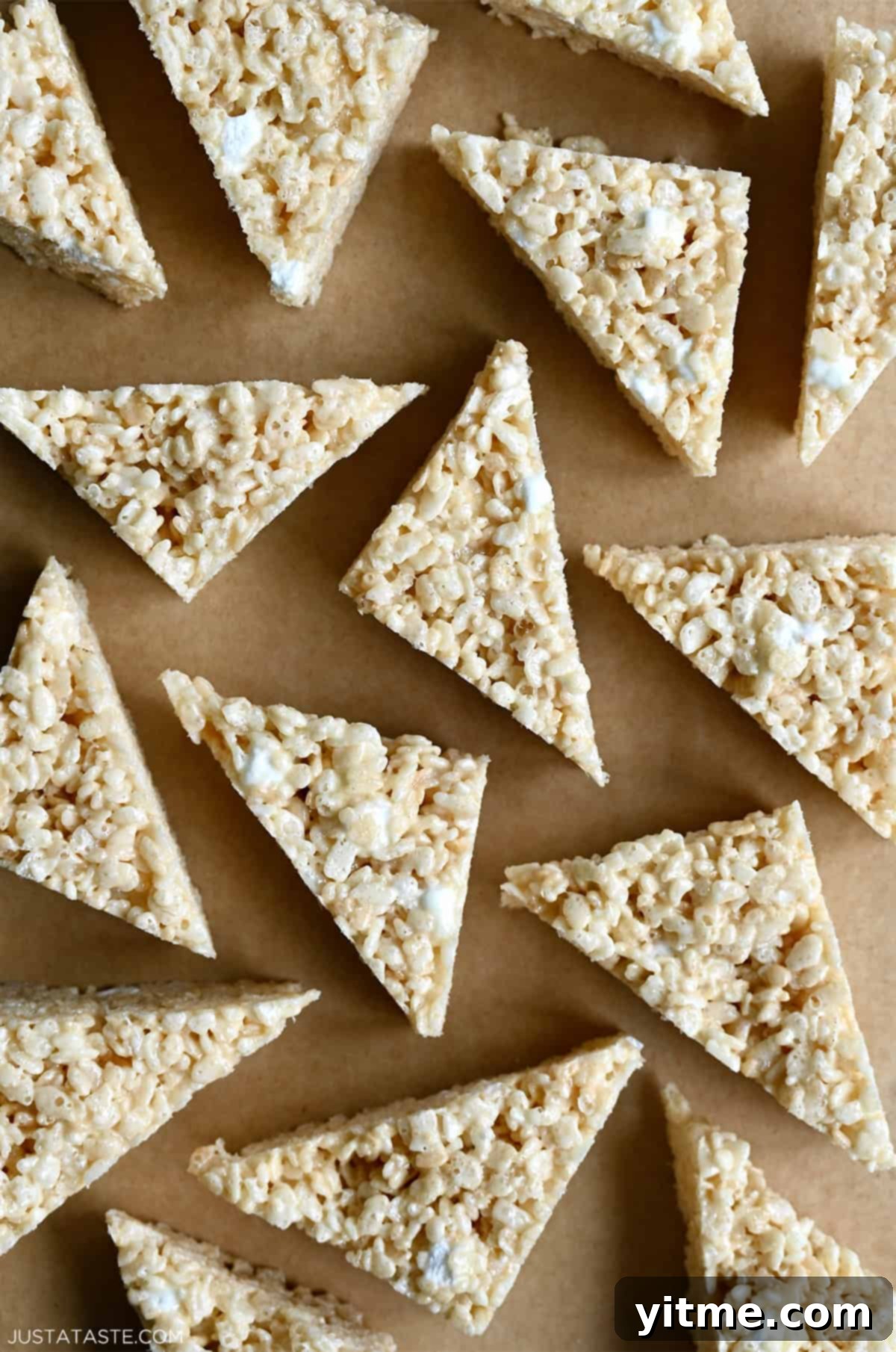 Gooey crispy marshmallow treats cut into triangles.