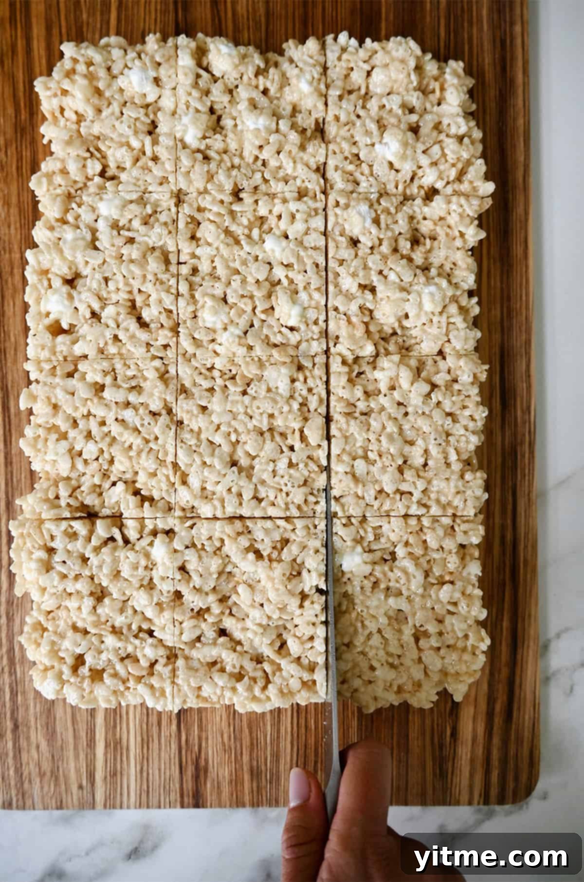 Slicing marshmallow treats into squares.