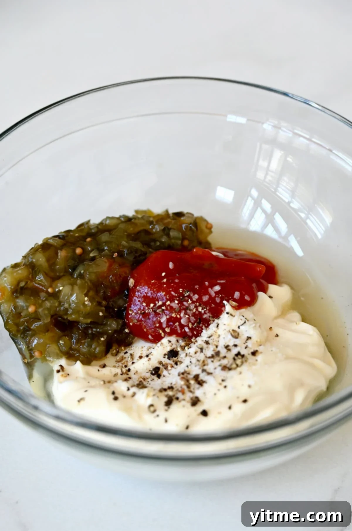 In-N-Out Style Burger Spread 4 Pickle relish, ketchup, mayonnaise and apple cider vinegar in a bowl before being mixed together.