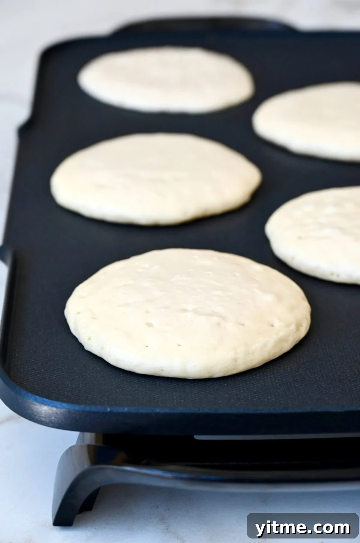 Cloud-Like Cottage Cheese Pancakes 8 Step-by-step instructions for making cottage cheese pancakes: cooking pancakes on a griddle.
