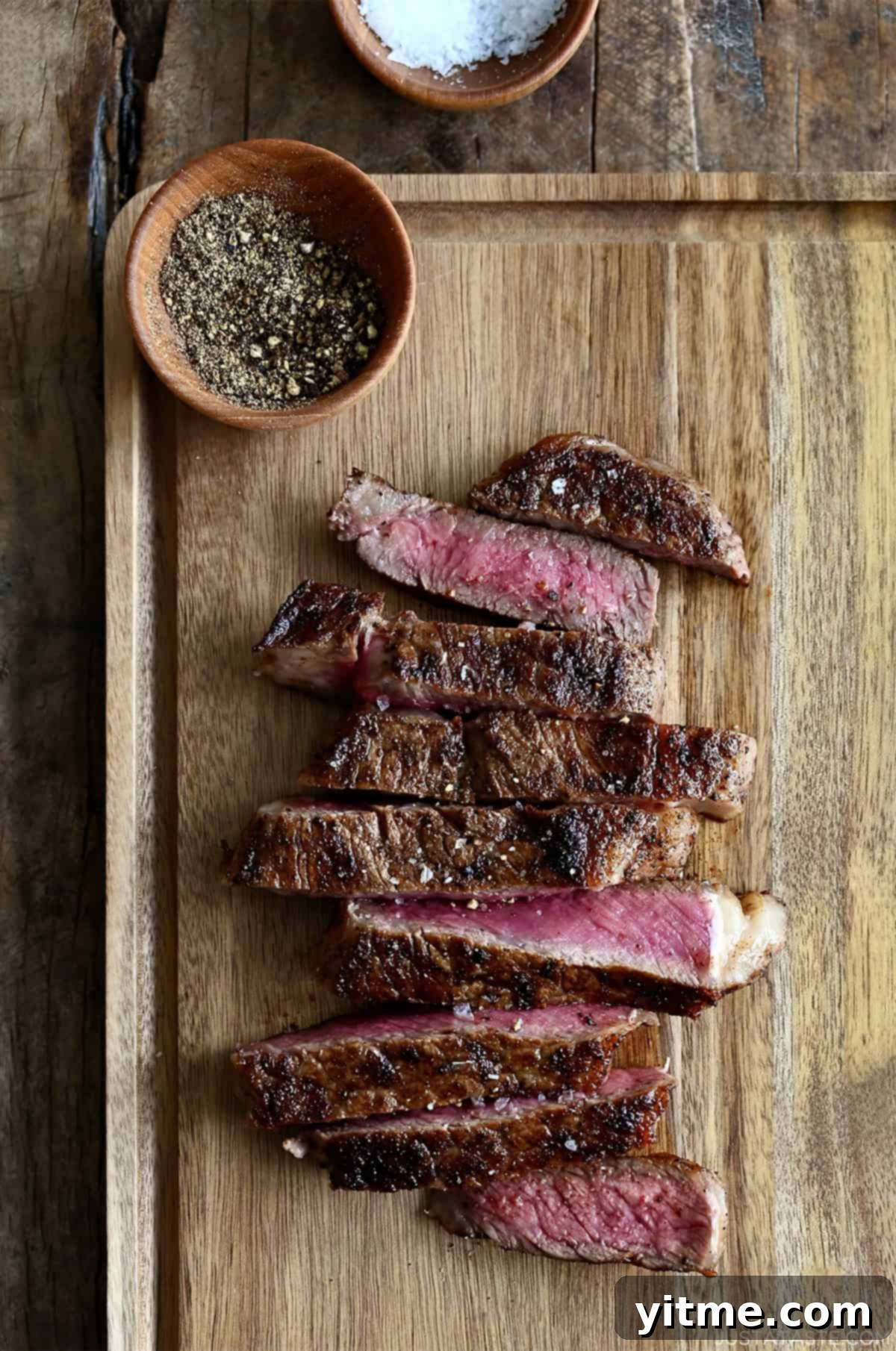 Perfectly sliced pan-seared steak revealing a juicy pink center and a beautifully golden-brown crust.
