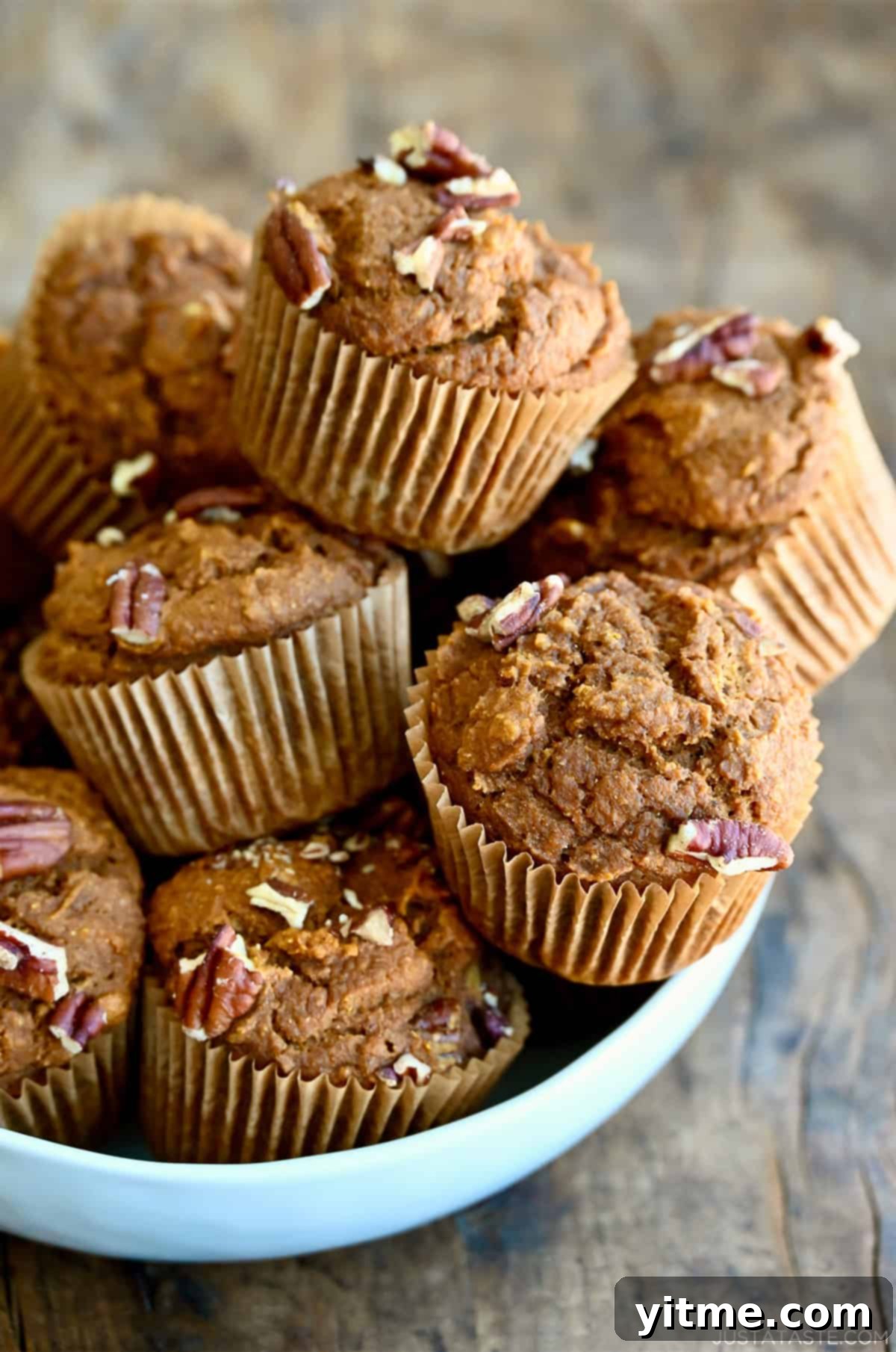 Wholesome Pumpkin Delights 12 A bowl overflowing with healthy pumpkin muffins studded with pecans.