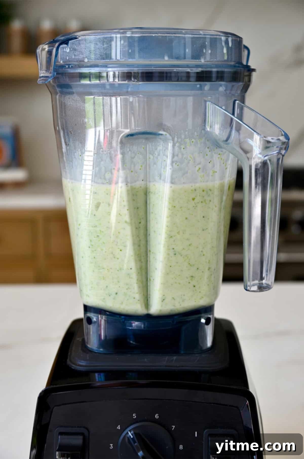 Creamy Broccoli Cheddar Soup 11 A blender containing creamy cheddar cheese and broccoli soup.