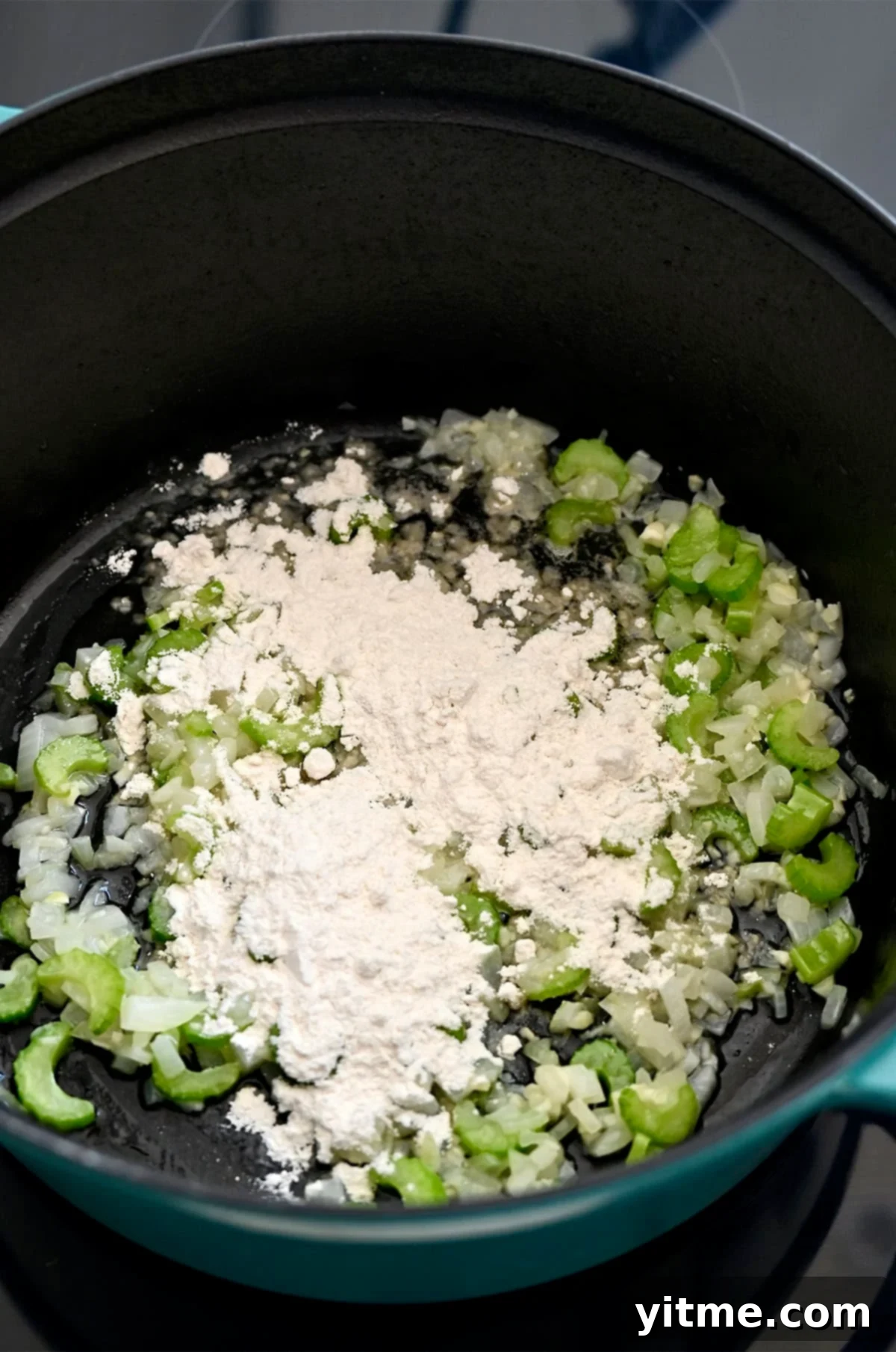Creamy Broccoli Cheddar Soup 7 Step two in making broccoli soup: Adding flour to the stockpot with sautéed aromatics and butter to make a quick roux.