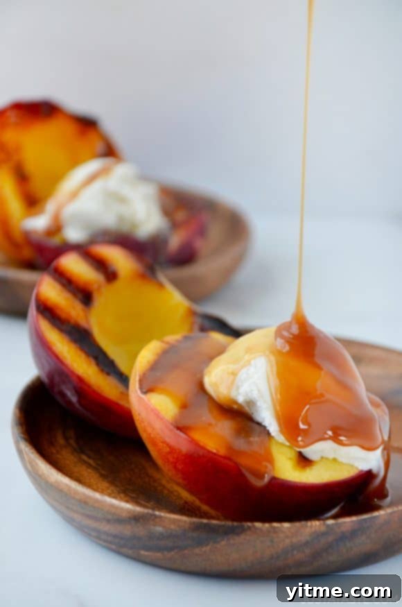 Grilled peach sundaes, dripping with a luscious boozy caramel sauce and topped with creamy vanilla ice cream, a perfect summer indulgence.
