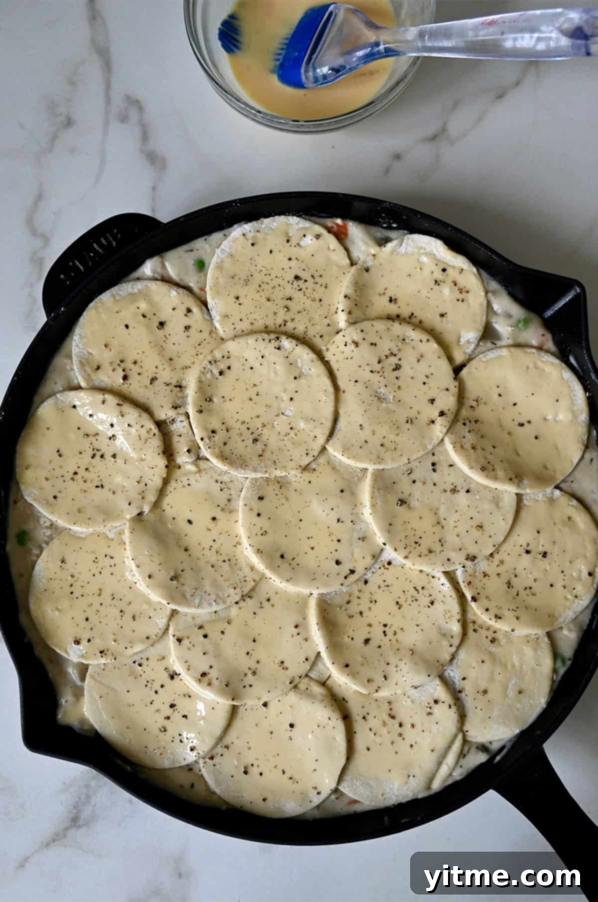 Puff pastry pot pie brushed with an egg wash before baking.