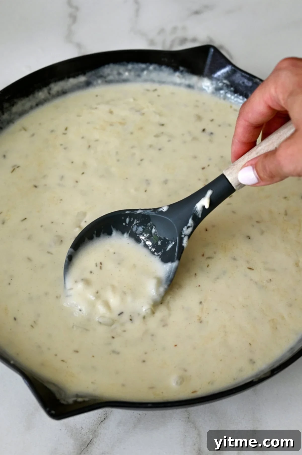 Thick and creamy pot pie sauce in a large oven-safe skillet.