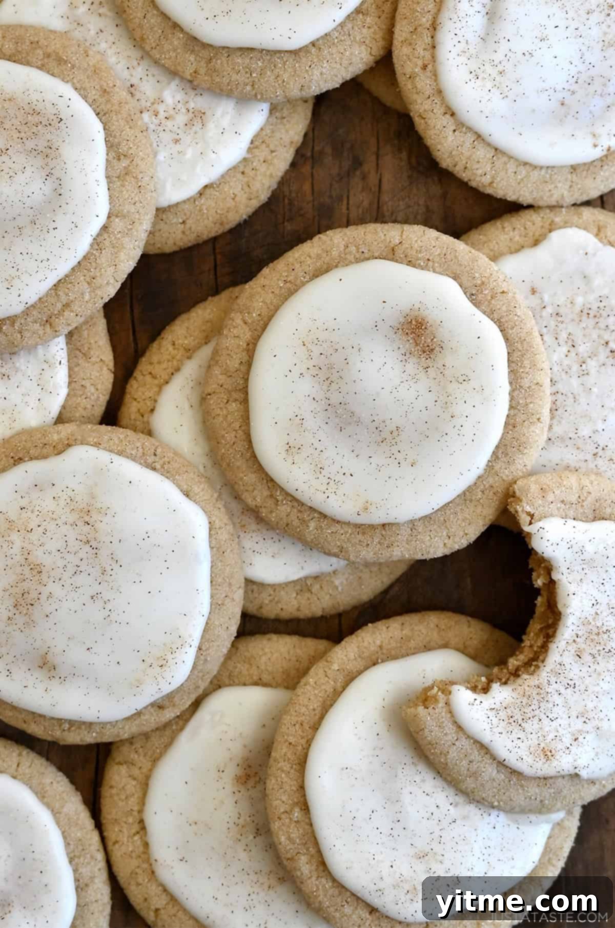 Taylor Swift chai cookies with eggnog icing piled atop each other with a bite taken out of one cookie.