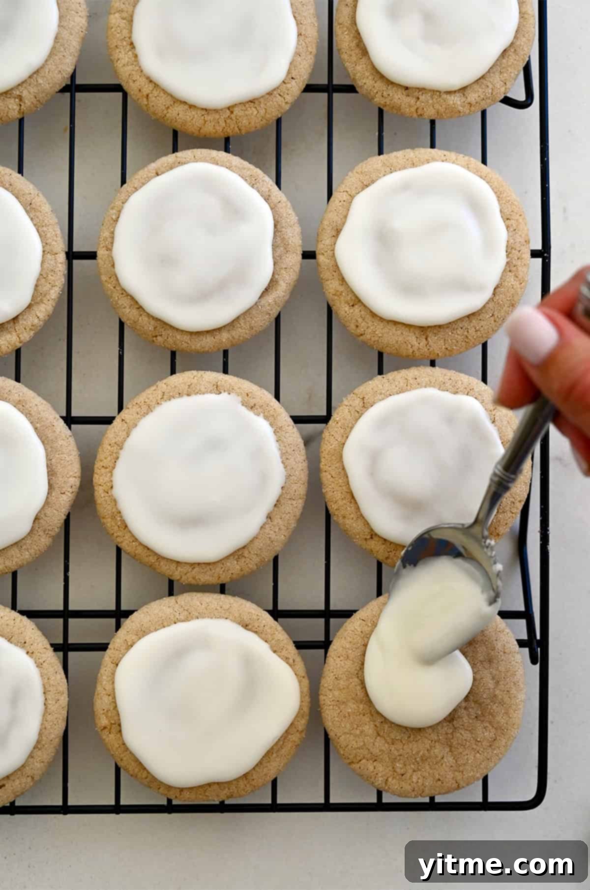 Spooning eggnog glaze over chai sugar cookies.
